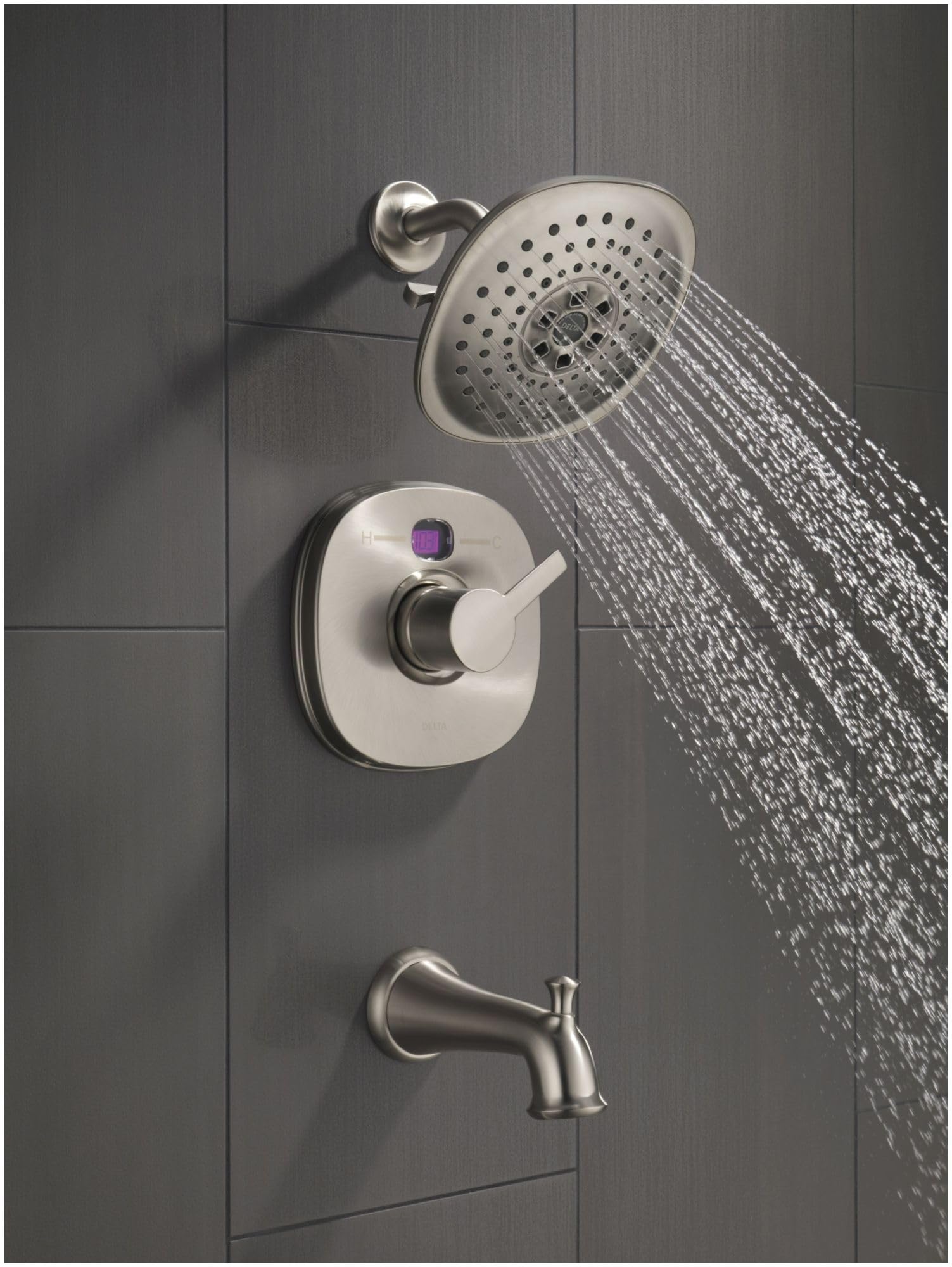 Black stainless steel shower system with round showerhead, valve trim with purple accent, and tub spout mounted on tile wall.