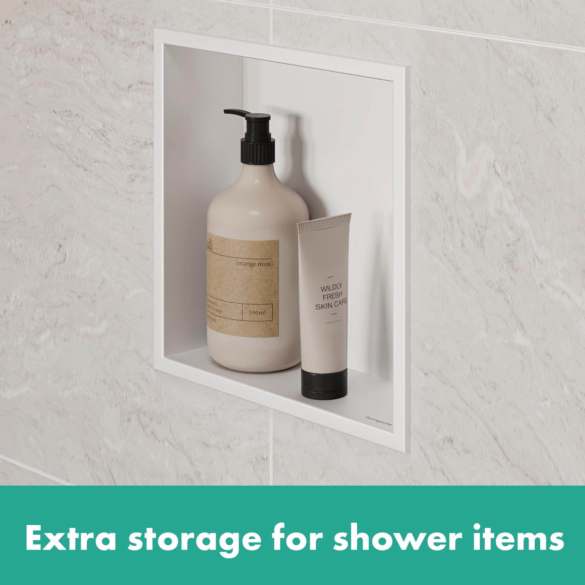 Matte white square wall niche with integrated frame containing soap bottle and skincare tube on marble bathroom wall.