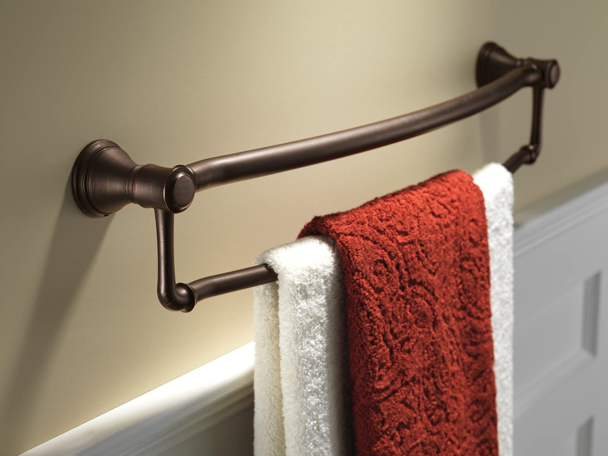 Oil-rubbed bronze dual towel bar with assist bar mounted on wall, displaying red and white towels.