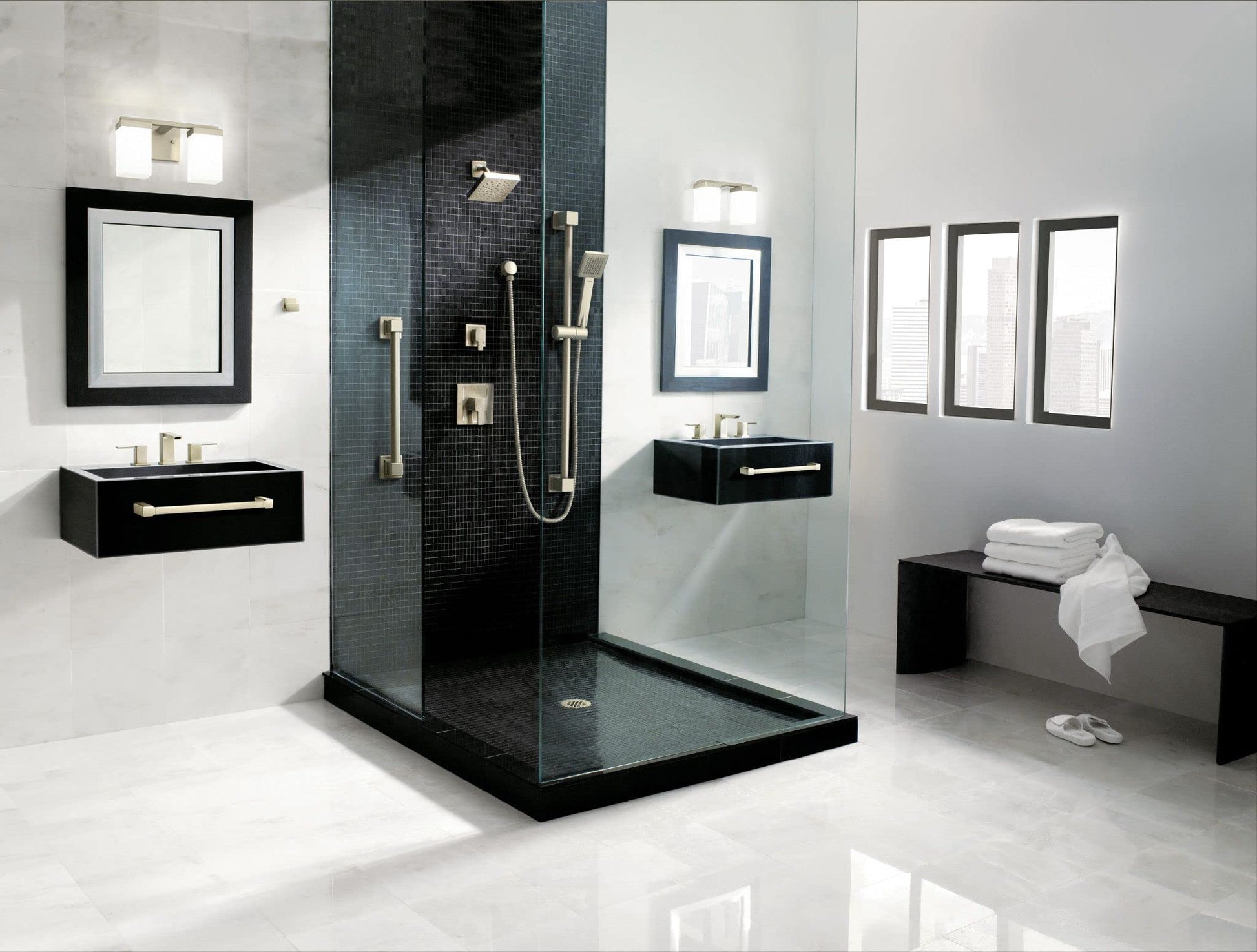 Chrome handheld shower with slide bar mounted on black tile shower wall in modern bathroom.