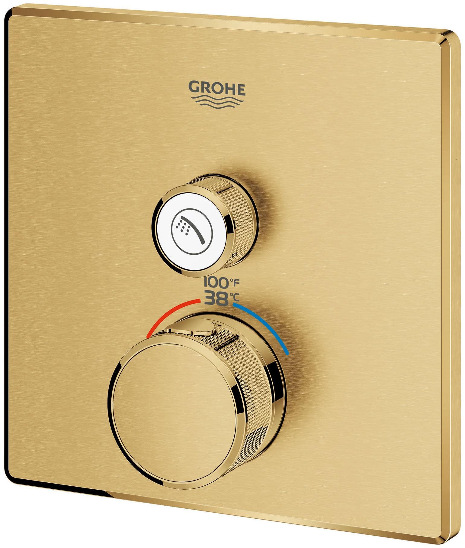 Grohe Grohtherm thermostatic valve trim with brushed gold square plate, two knobs, and temperature dial showing 100°F and 38°