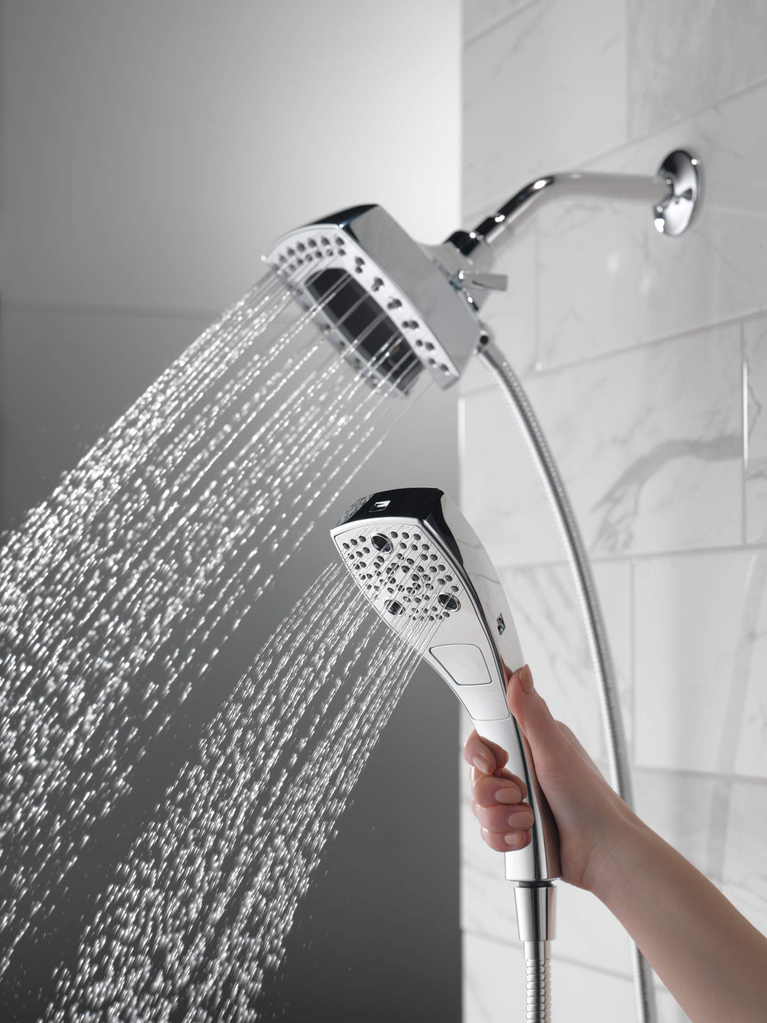 Chrome two-in-one shower system with fixed overhead head and handheld spray, both with perforated nozzle faces, mounted on wh