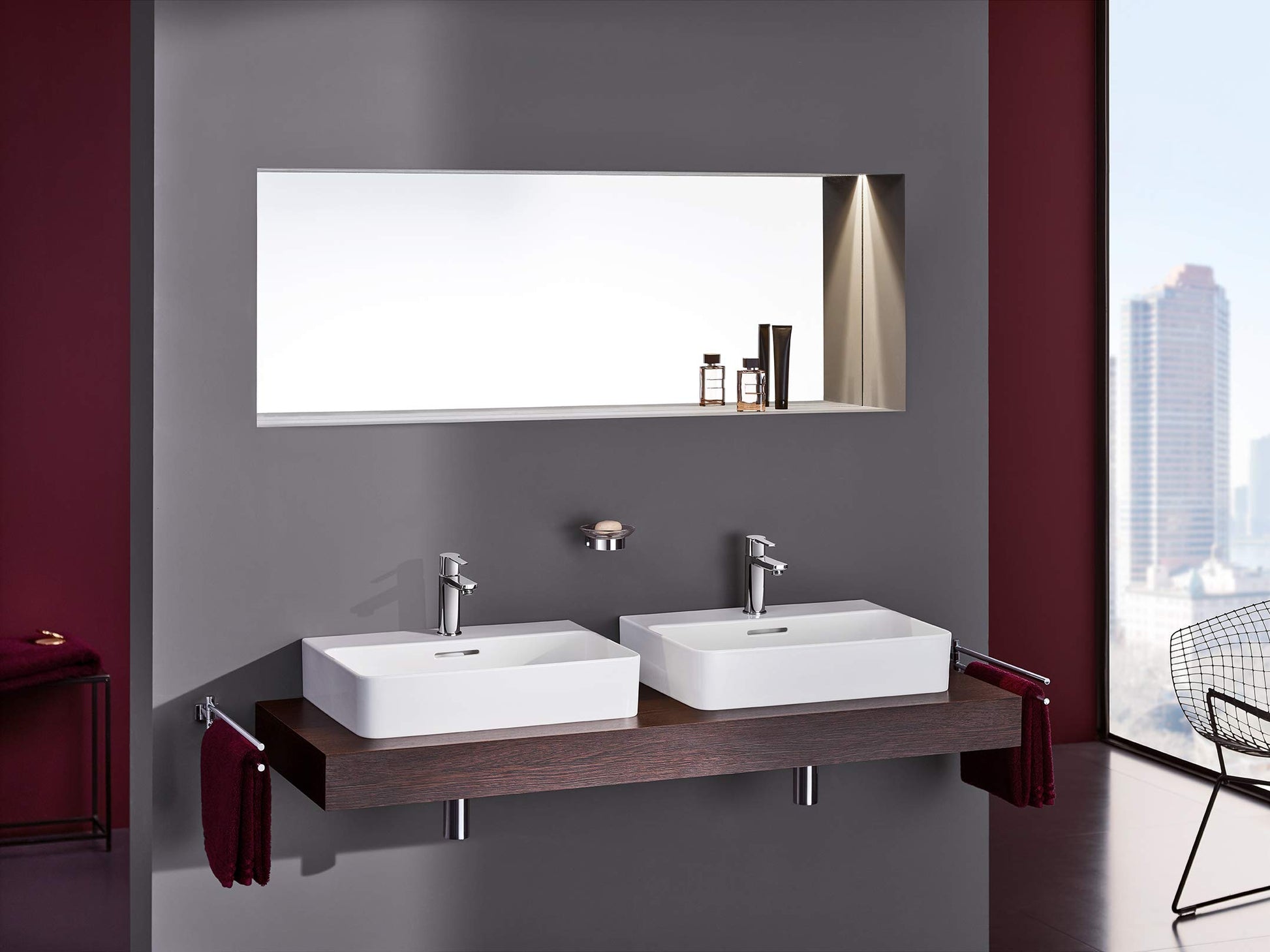 Chrome single-handle bathroom faucet with tall spout installed on white vessel sink.