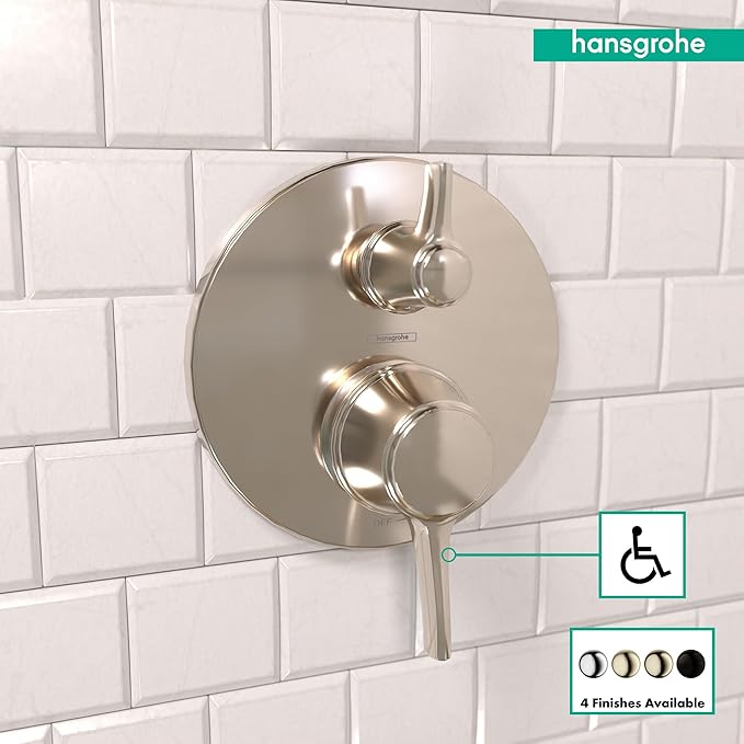 Polished nickel round pressure balance valve trim with dual handles and diverter on white subway tile.