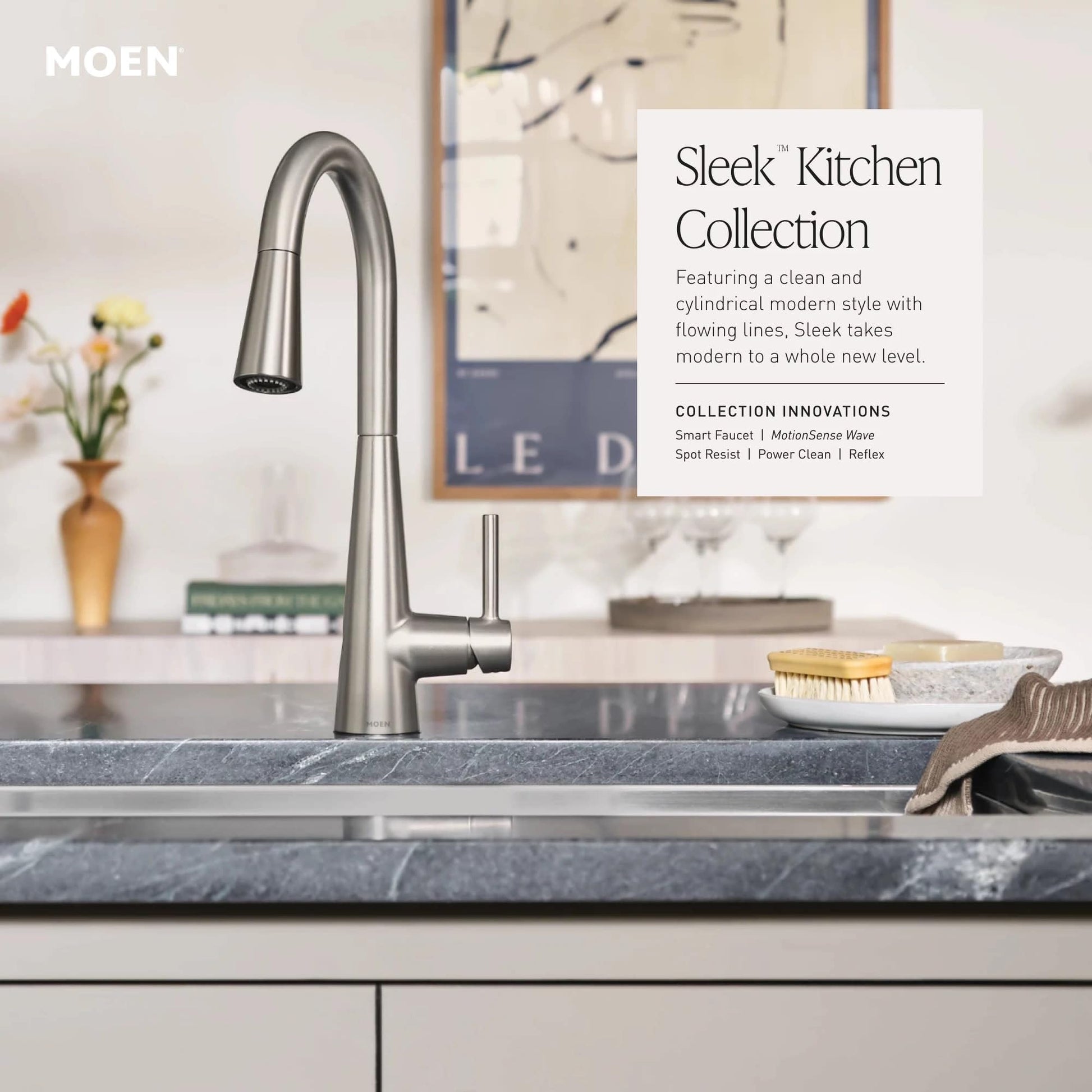 Matte black single-handle kitchen faucet with high arc pulldown sprayer head mounted on gray countertop.