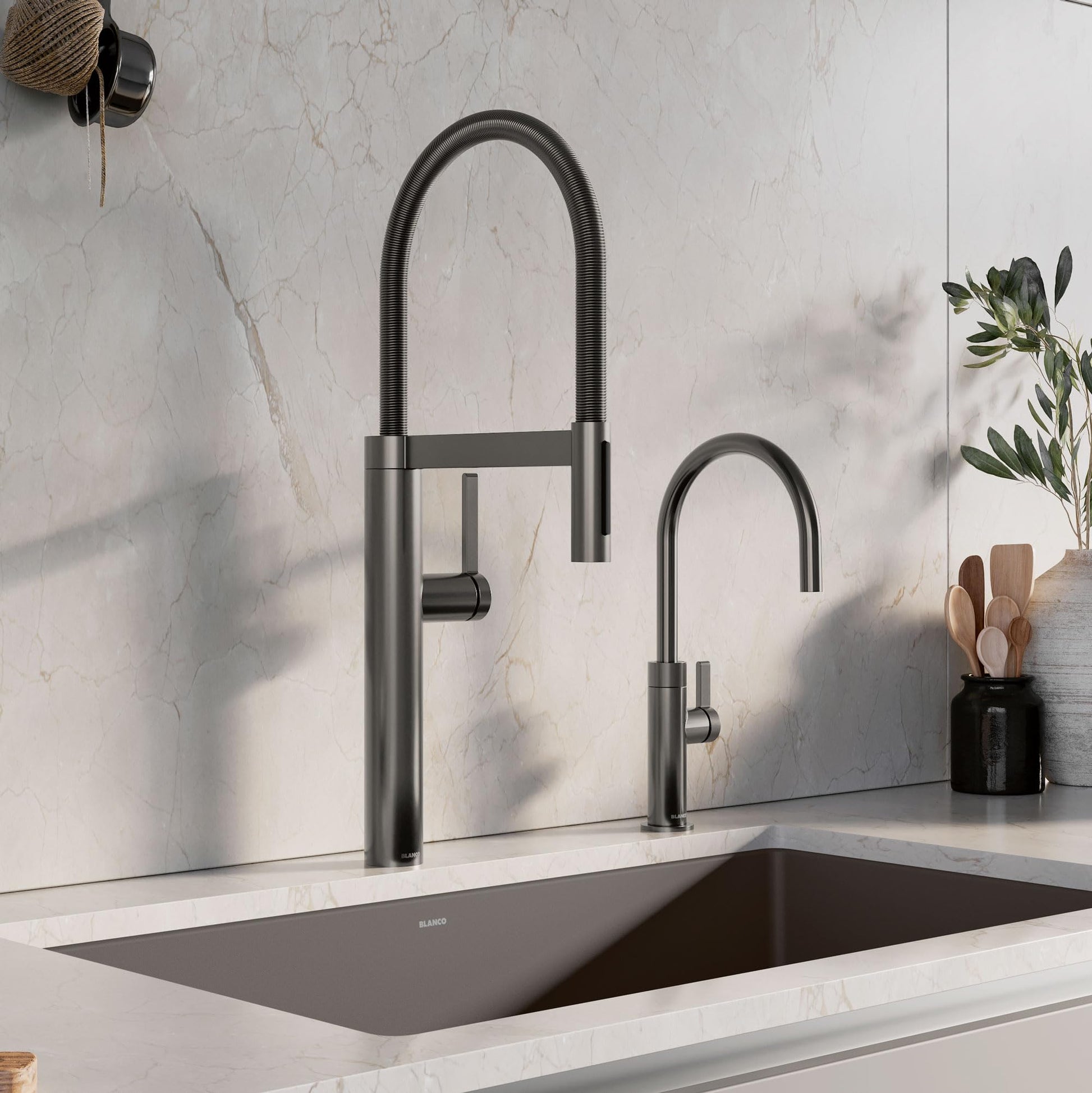 Satin dark steel beverage faucet with flexible hose spray and separate smaller faucet installed above kitchen sink.