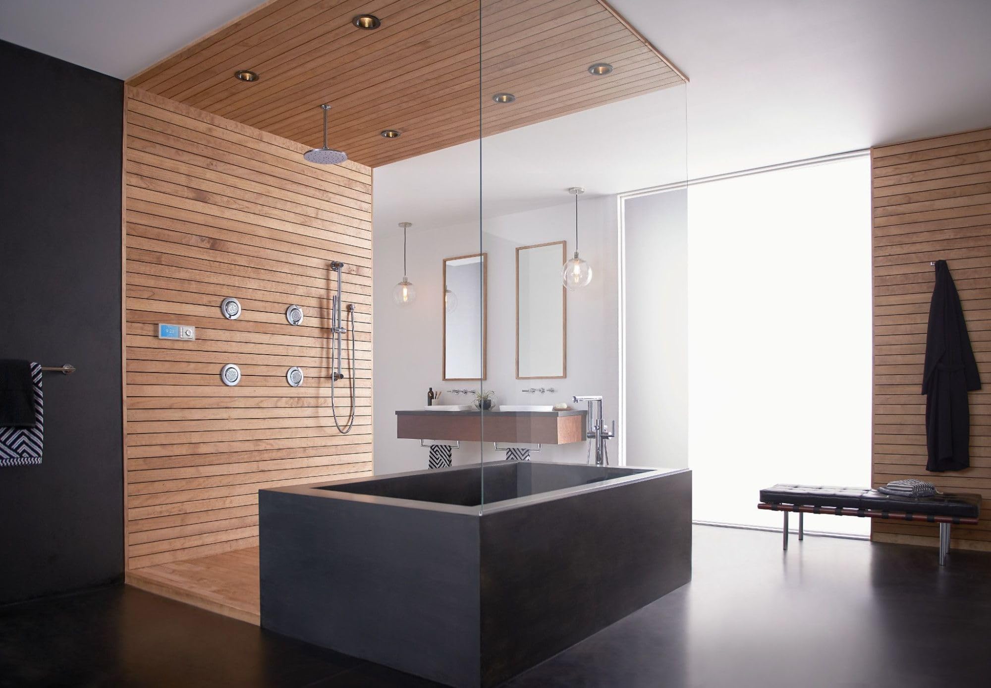 Chrome round body spray fixtures mounted on wooden shower wall with multiple spray functions.