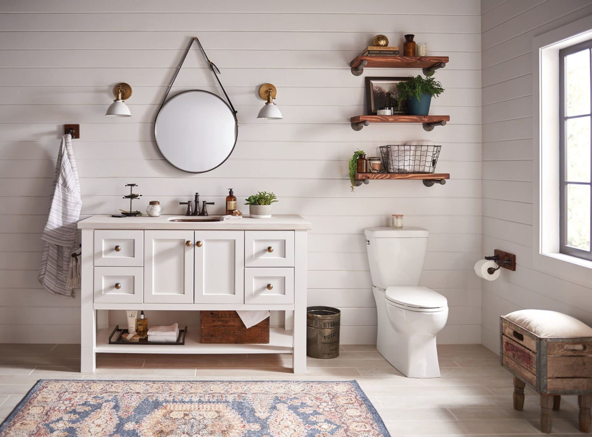Oil-rubbed bronze toilet paper holder mounted on bathroom wall beside toilet.