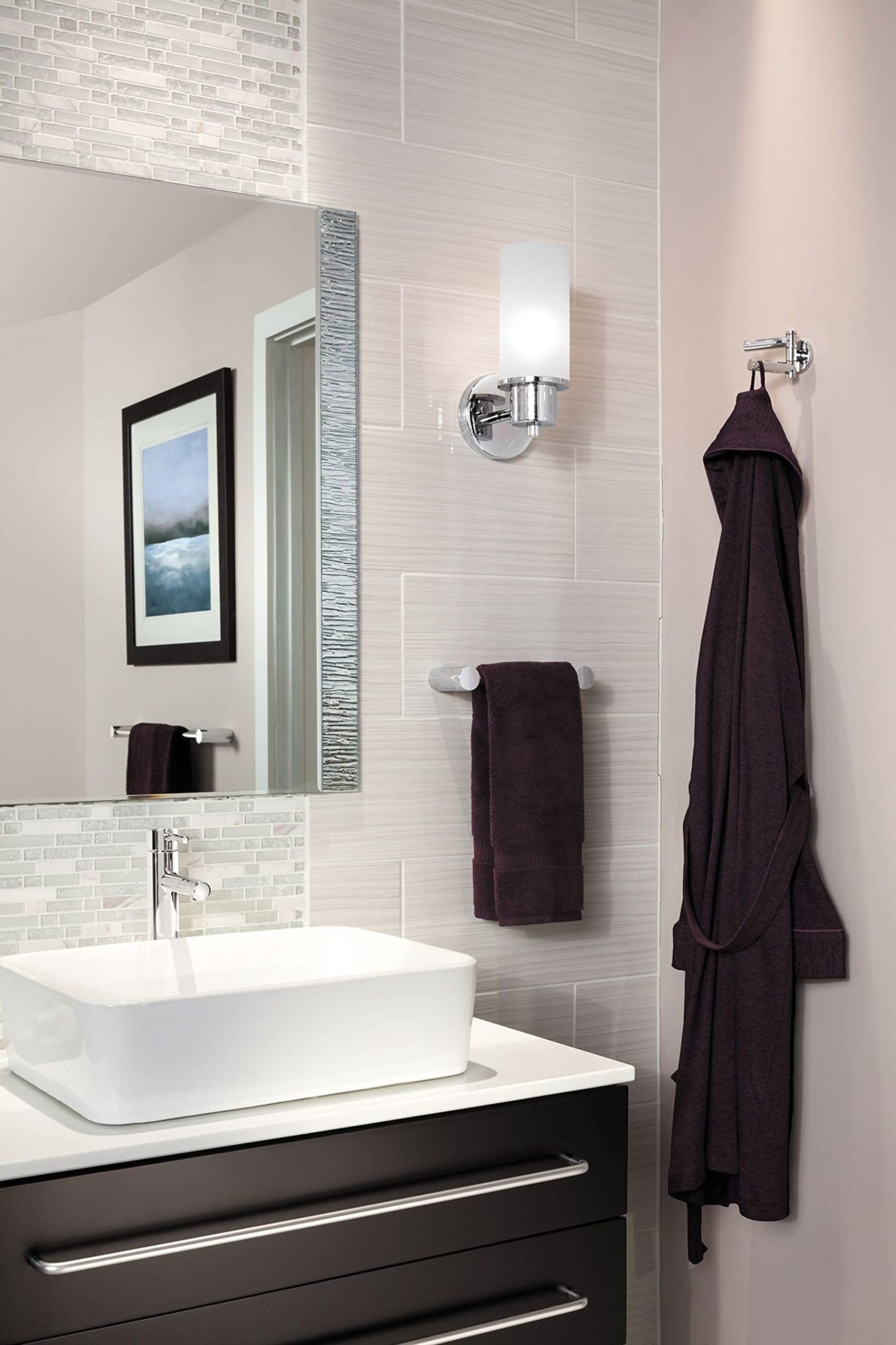 Chrome double swivel robe hook mounted on bathroom wall holding dark towel and robe.