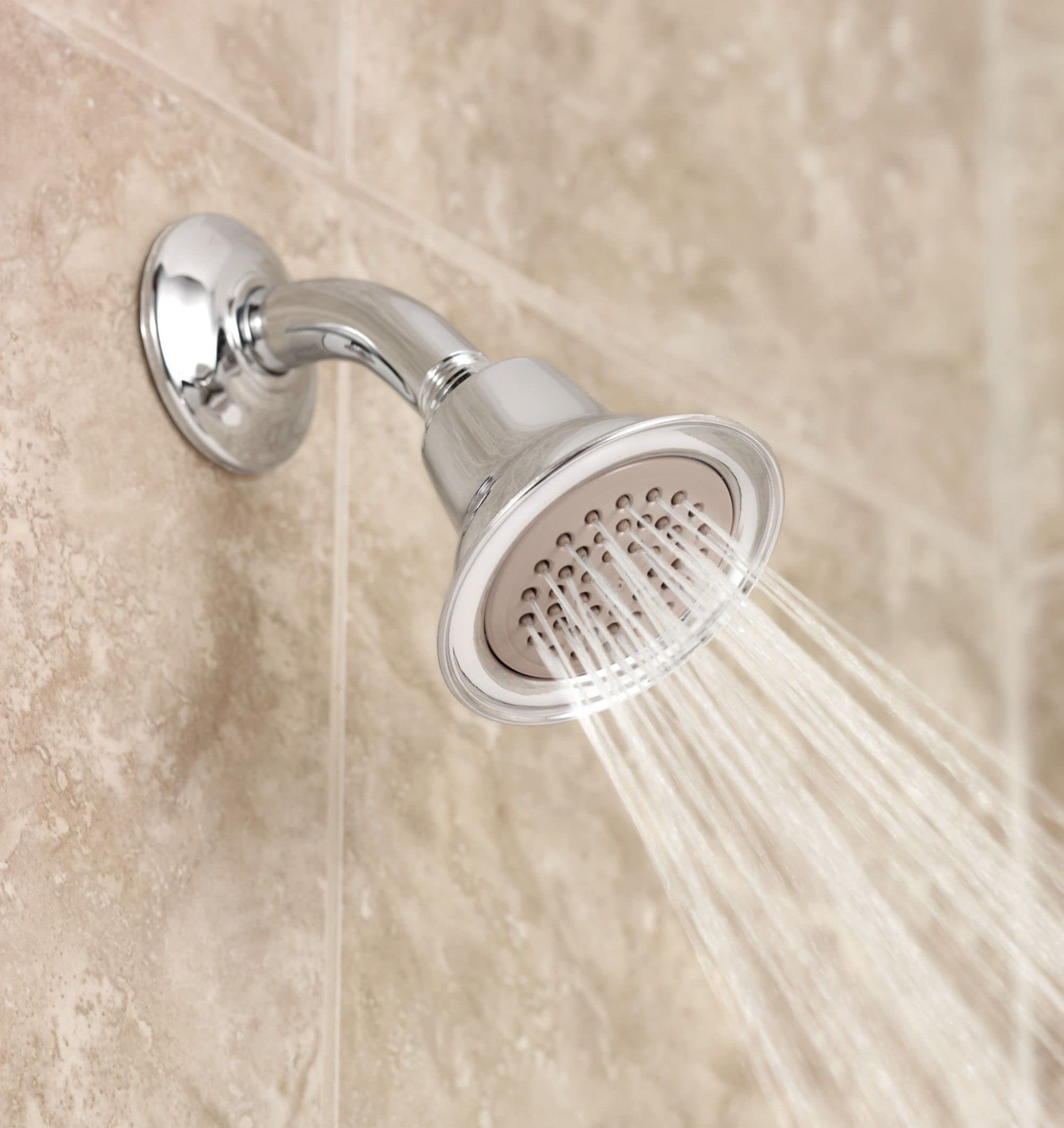 Brushed nickel single-function shower head with round face and curved arm mounted on tile wall with water streams visible.