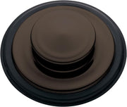 Oil rubbed bronze sink stopper with domed center and dark rubber rim, viewed from above.