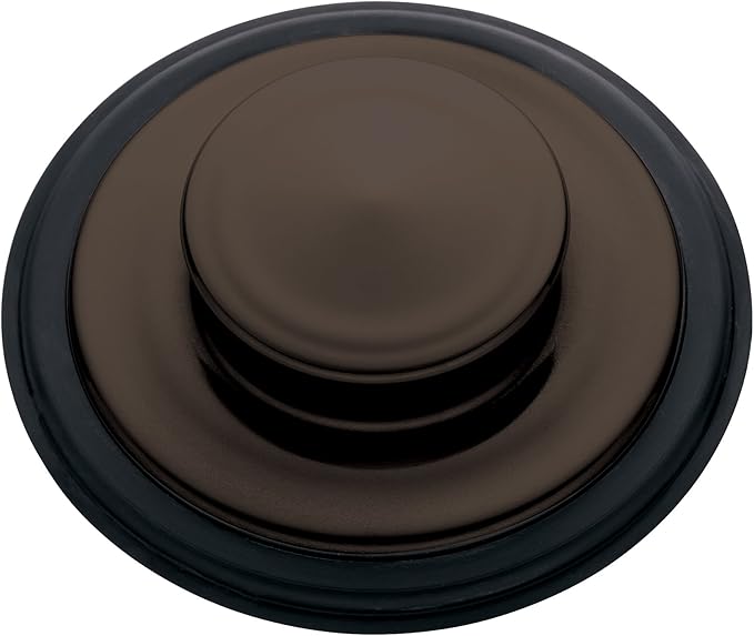 Oil rubbed bronze sink stopper with domed center and dark rubber rim, viewed from above.