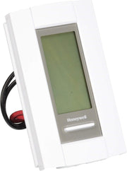 White Honeywell thermostat with green LCD display and attached black and red wires.