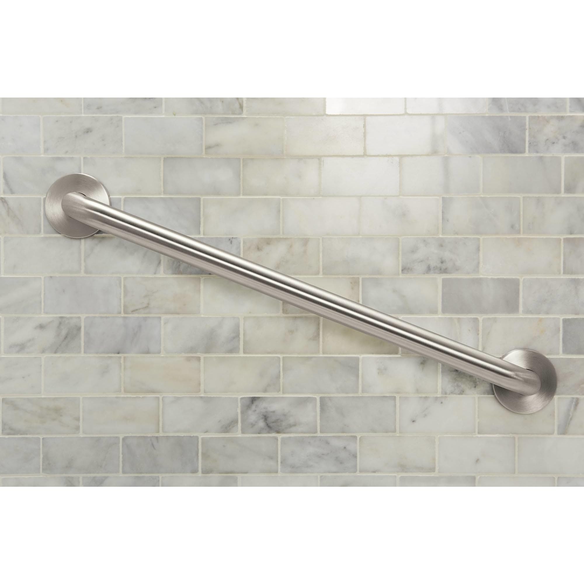 Brushed nickel cylindrical grab bar mounted horizontally on marble subway tile wall.