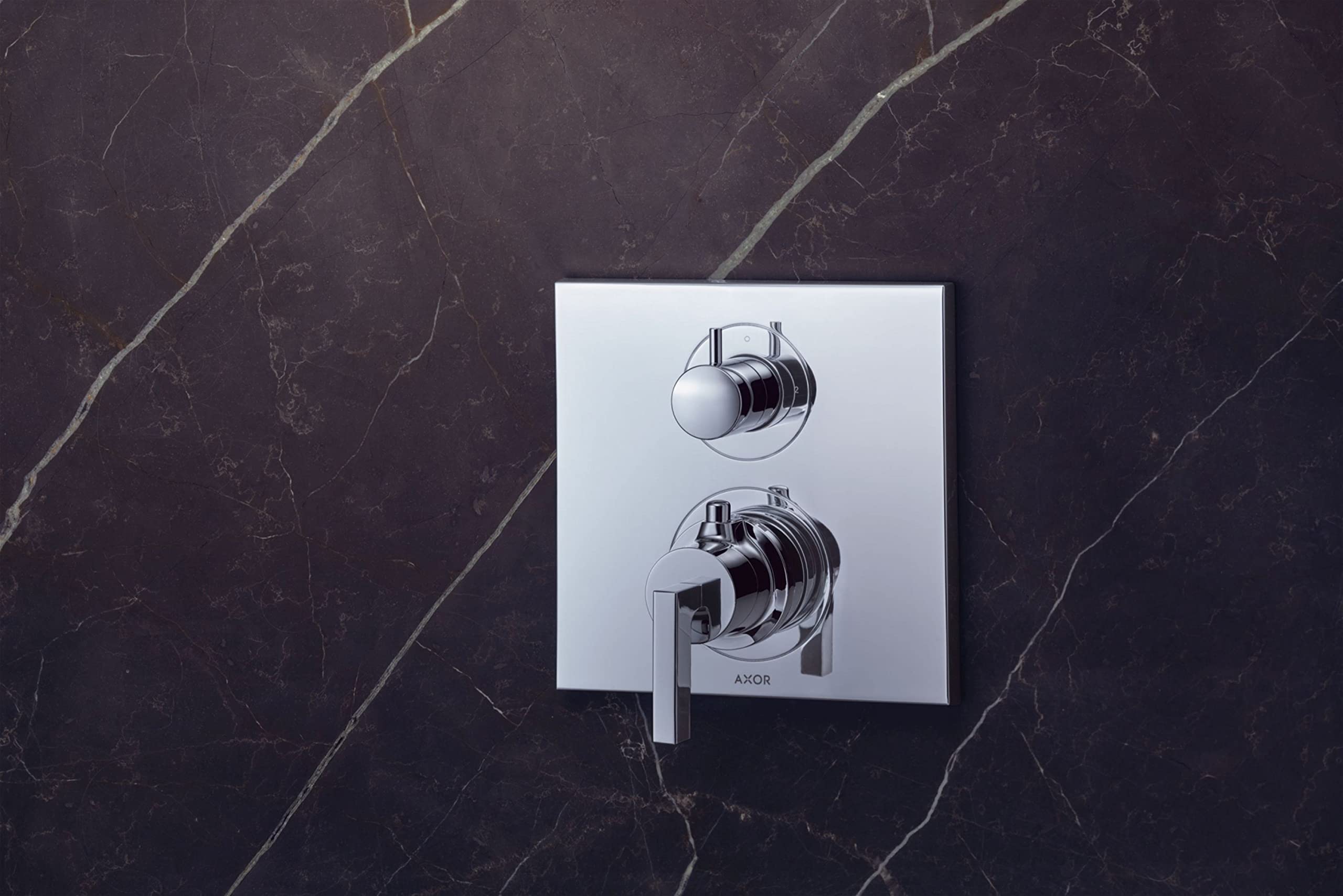 Chrome thermostatic shower trim with round volume control knob and rectangular lever handle mounted on white plate.