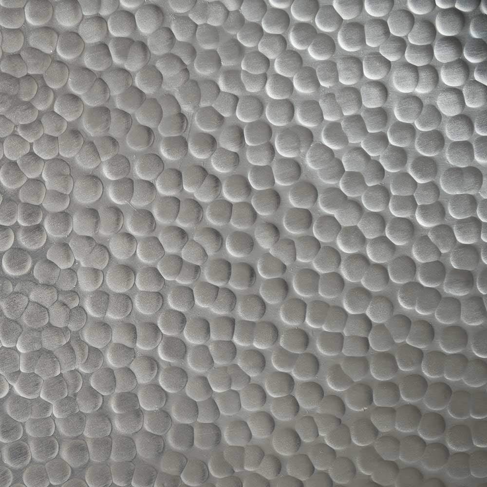 Hammered copper surface with dense, raised circular dimple pattern covering entire area.