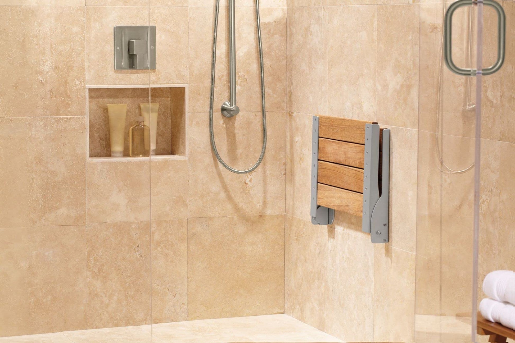 Brushed nickel single-handle shower valve trim with 90-degree design mounted on tiled shower wall with overhead and handheld 