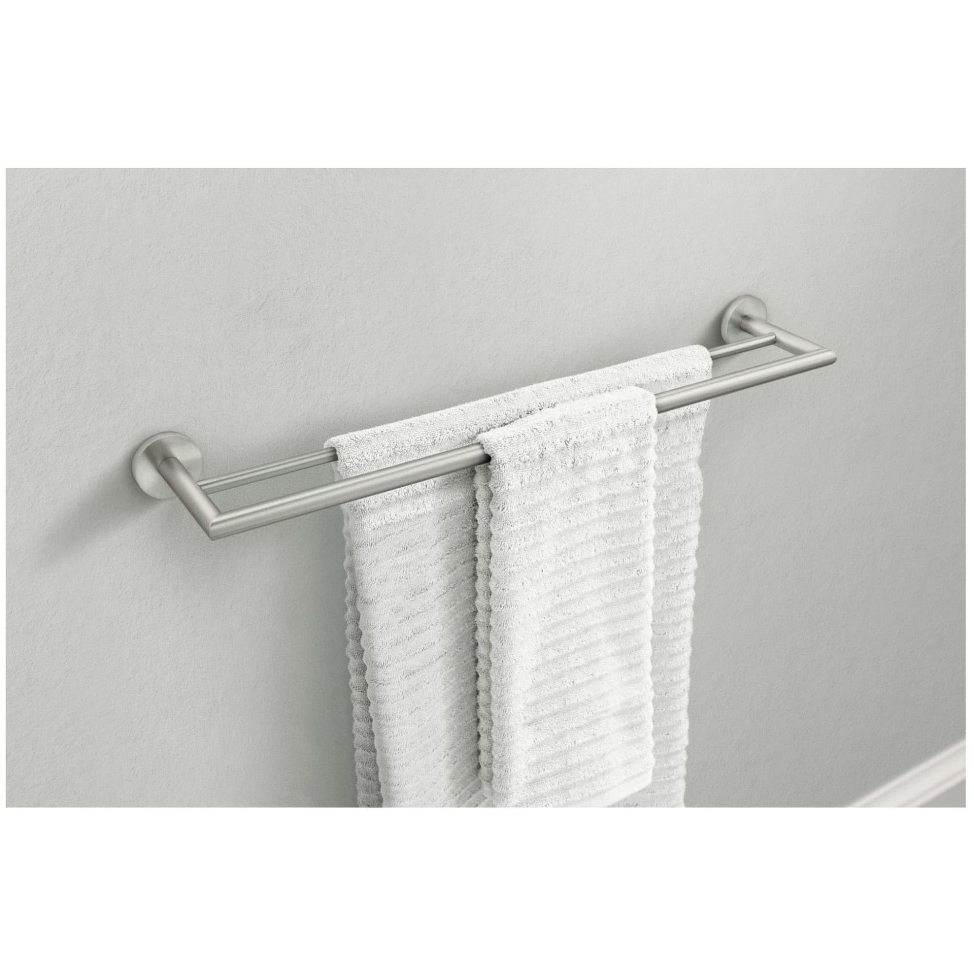 Chrome double towel bar with two horizontal bars mounted on white wall, holding two white towels.