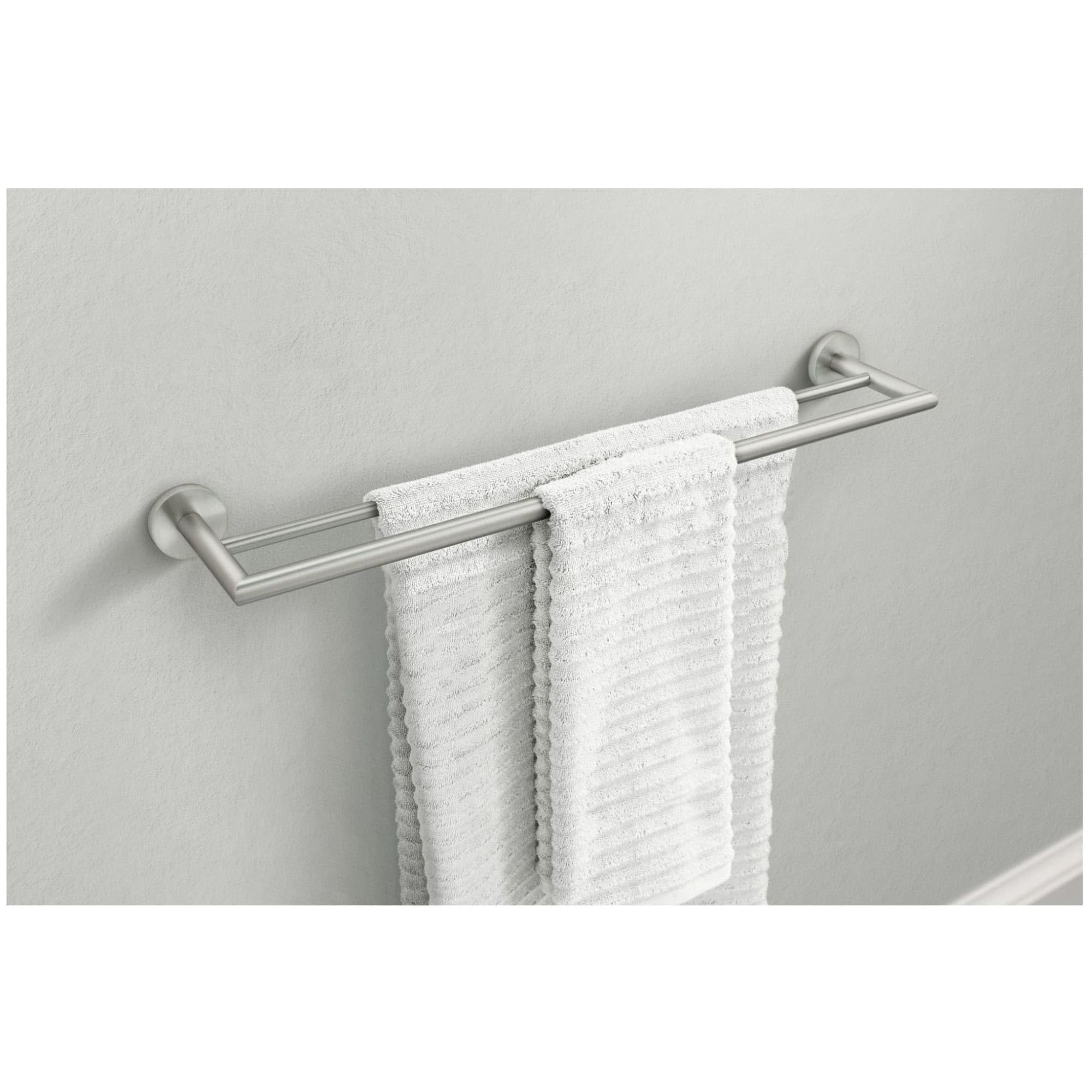 Chrome double towel bar with two horizontal bars mounted on white wall, holding two white towels.