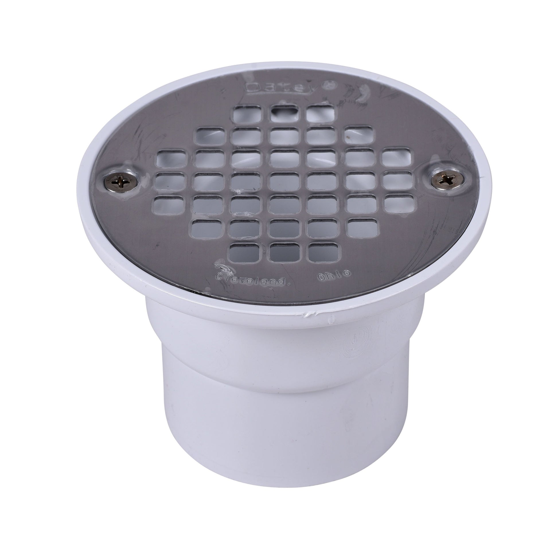 Black round shower drain strainer with grid pattern mounted on white PVC pipe fitting.