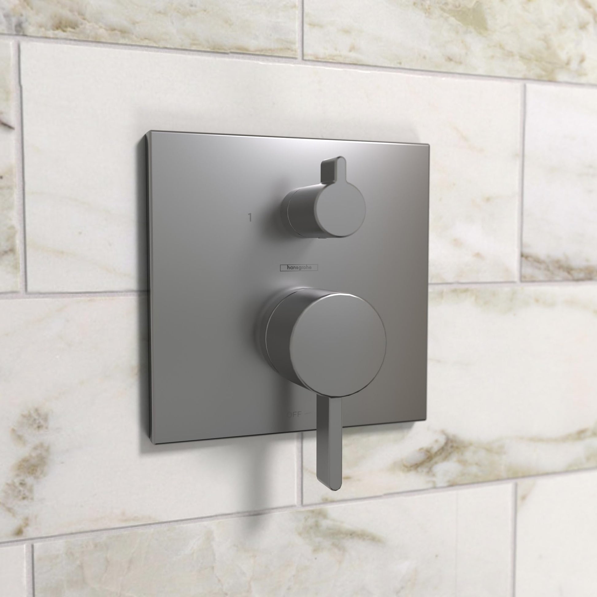 Brushed black chrome square shower valve trim with circular handle and small diverter lever mounted on tiled wall.