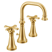 Brushed gold wall-mount bathroom faucet trim with curved spout and cross handles on two pedestal bases.