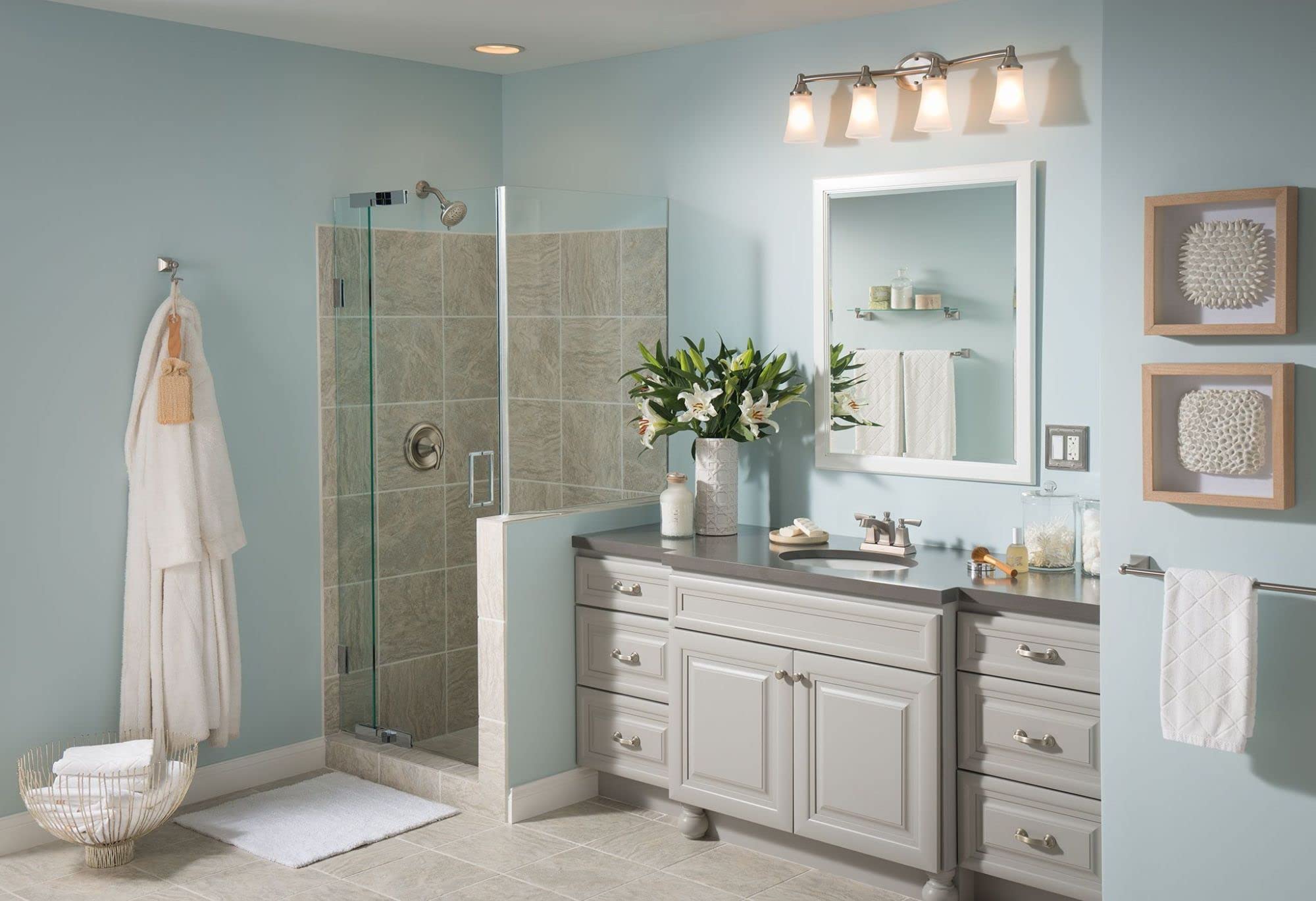 Brushed nickel wall-mounted towel ring installed on bathroom wall next to vanity sink.