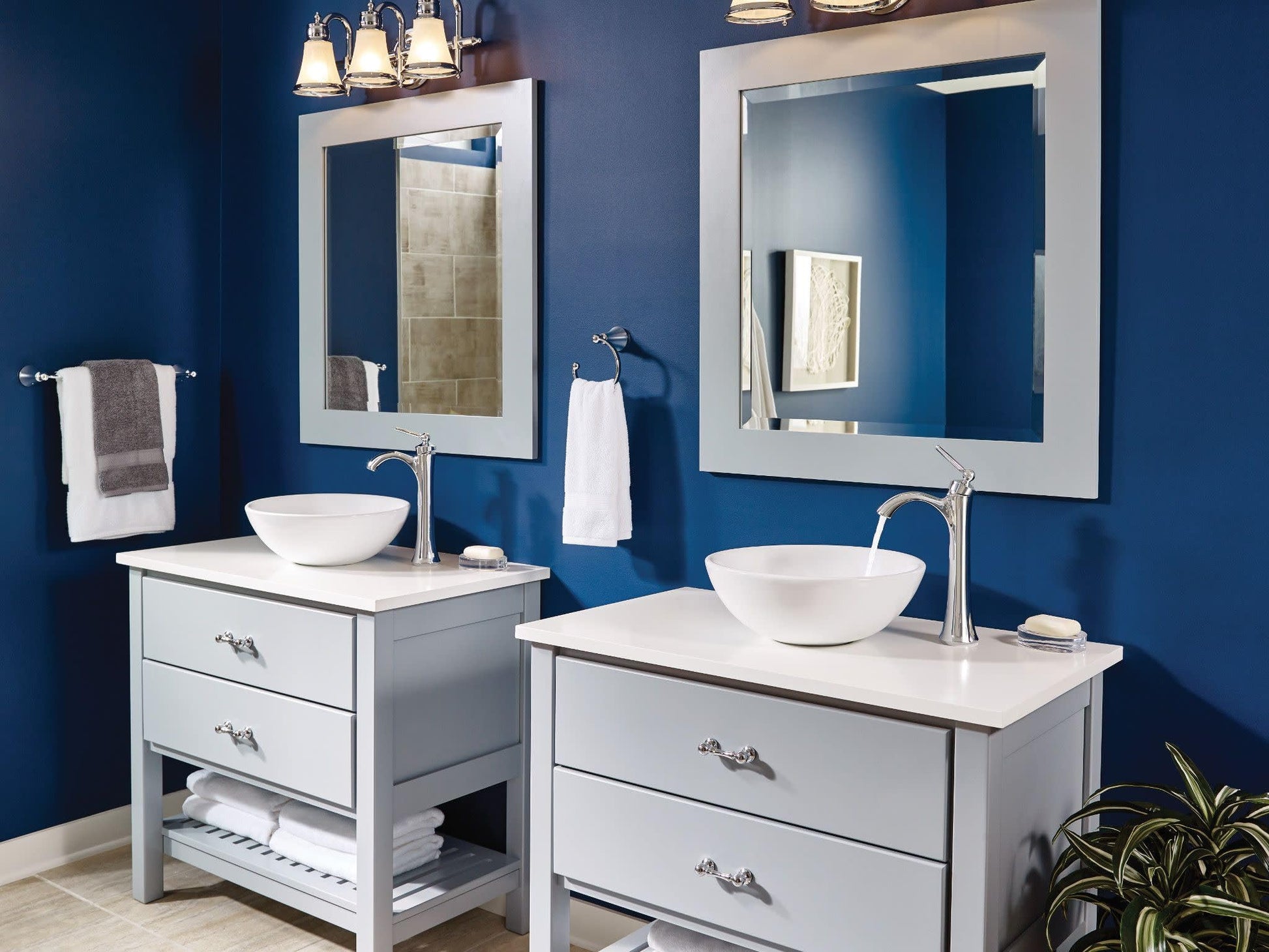 Chrome single-handle high-arc faucet installed above white vessel sink on bathroom vanity.