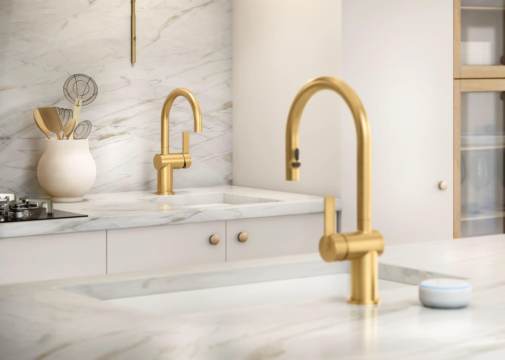 Brushed gold single-handle bar faucet with curved spout installed above white marble countertop sink.