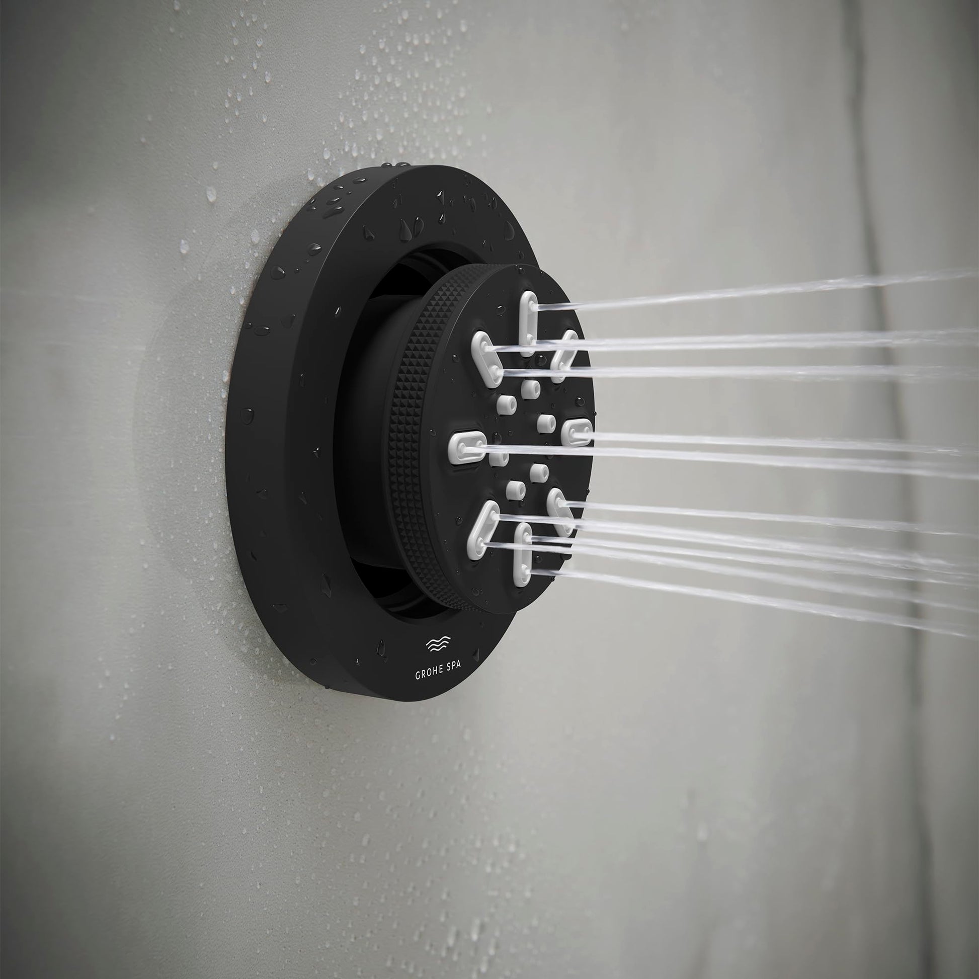 Matte black round body spray with two spray arms extending horizontally, mounted on white tile wall with water droplets.