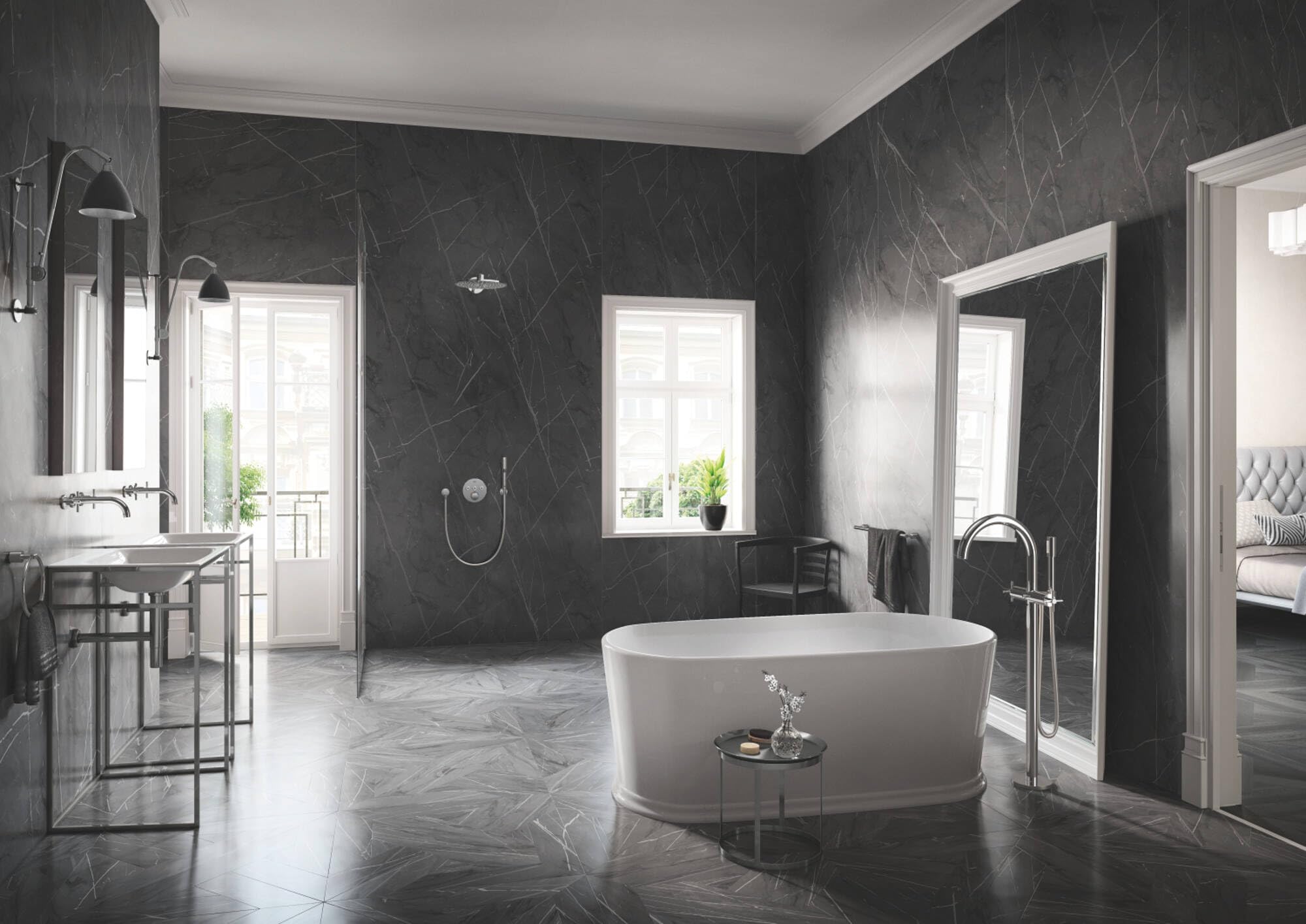 Chrome towel rail mounted horizontally on dark marble bathroom wall above bathtub.