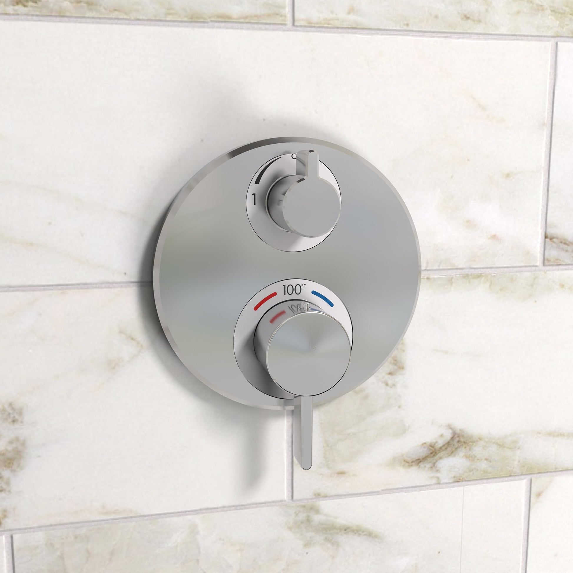 Chrome thermostatic valve trim with dual circular controls mounted on marble tile wall.