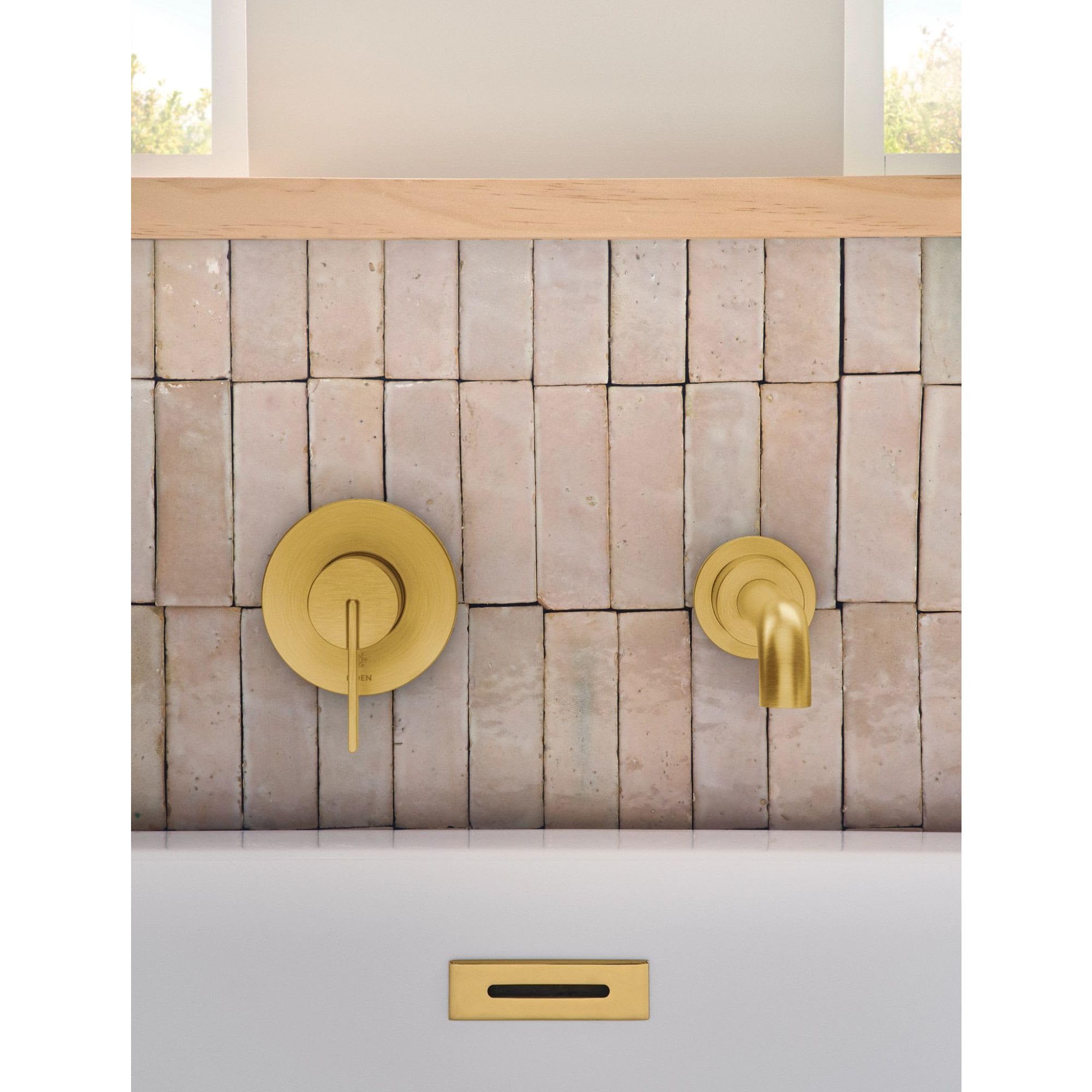 Matte black wall-mounted tub faucet with single handle and curved spout installed on vertical tile wall.