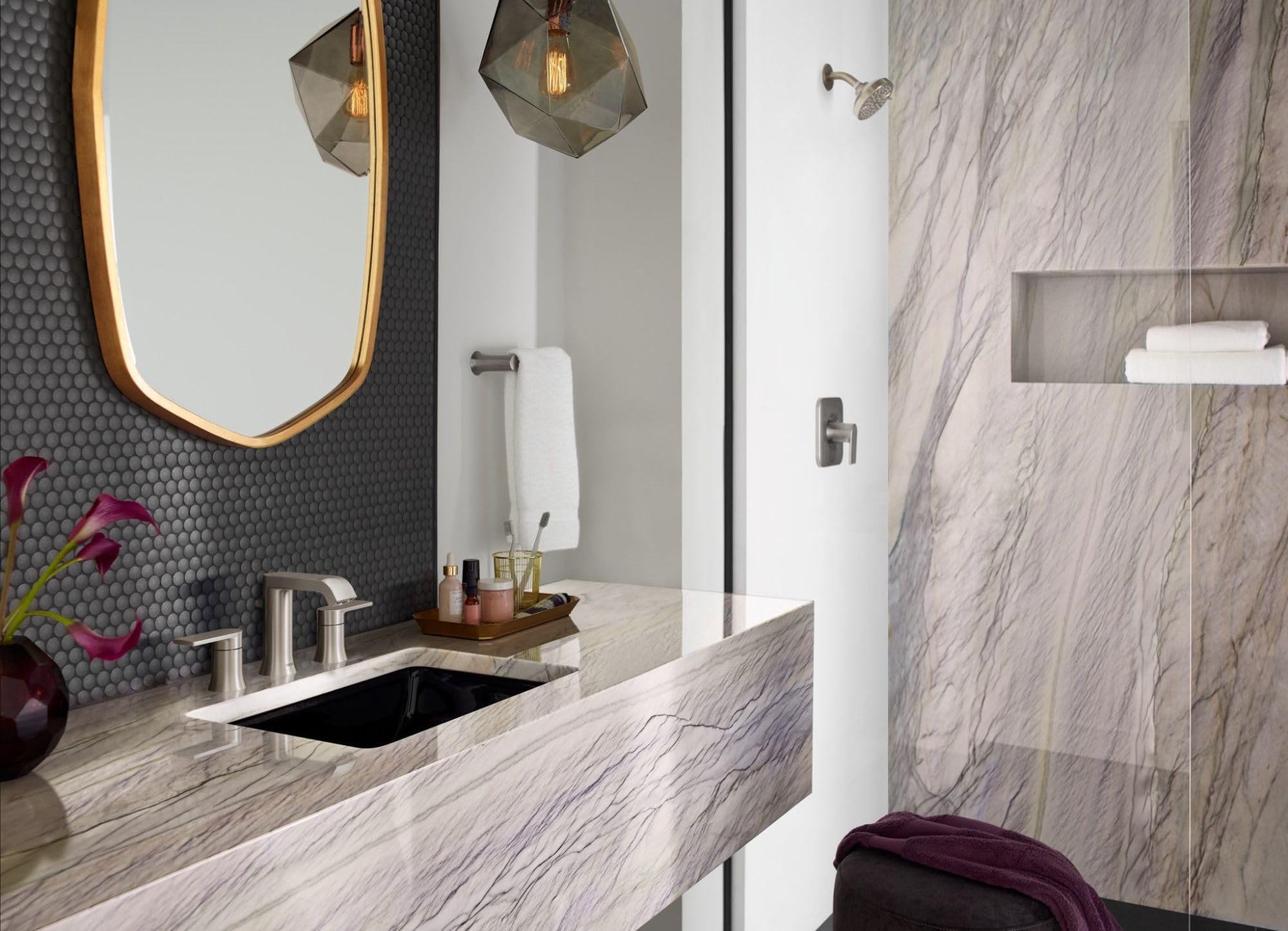 Brushed nickel hand towel bar mounted on white wall in bathroom vanity area.