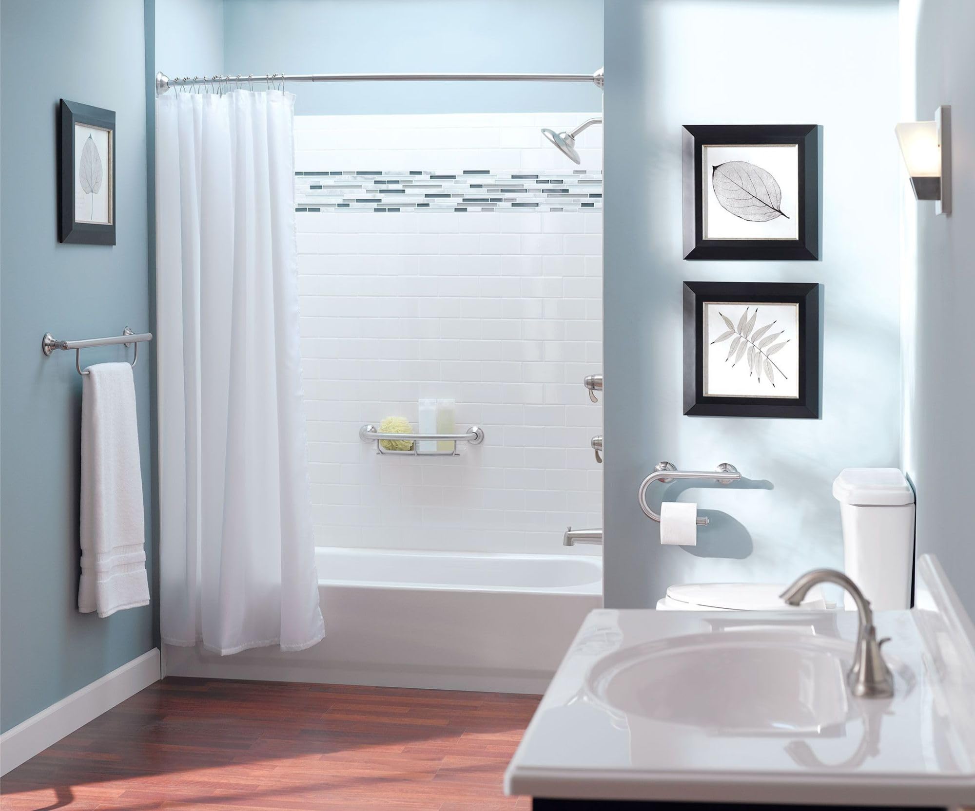 Chrome grab bar with integrated towel bar mounted on bathroom wall above bathtub.