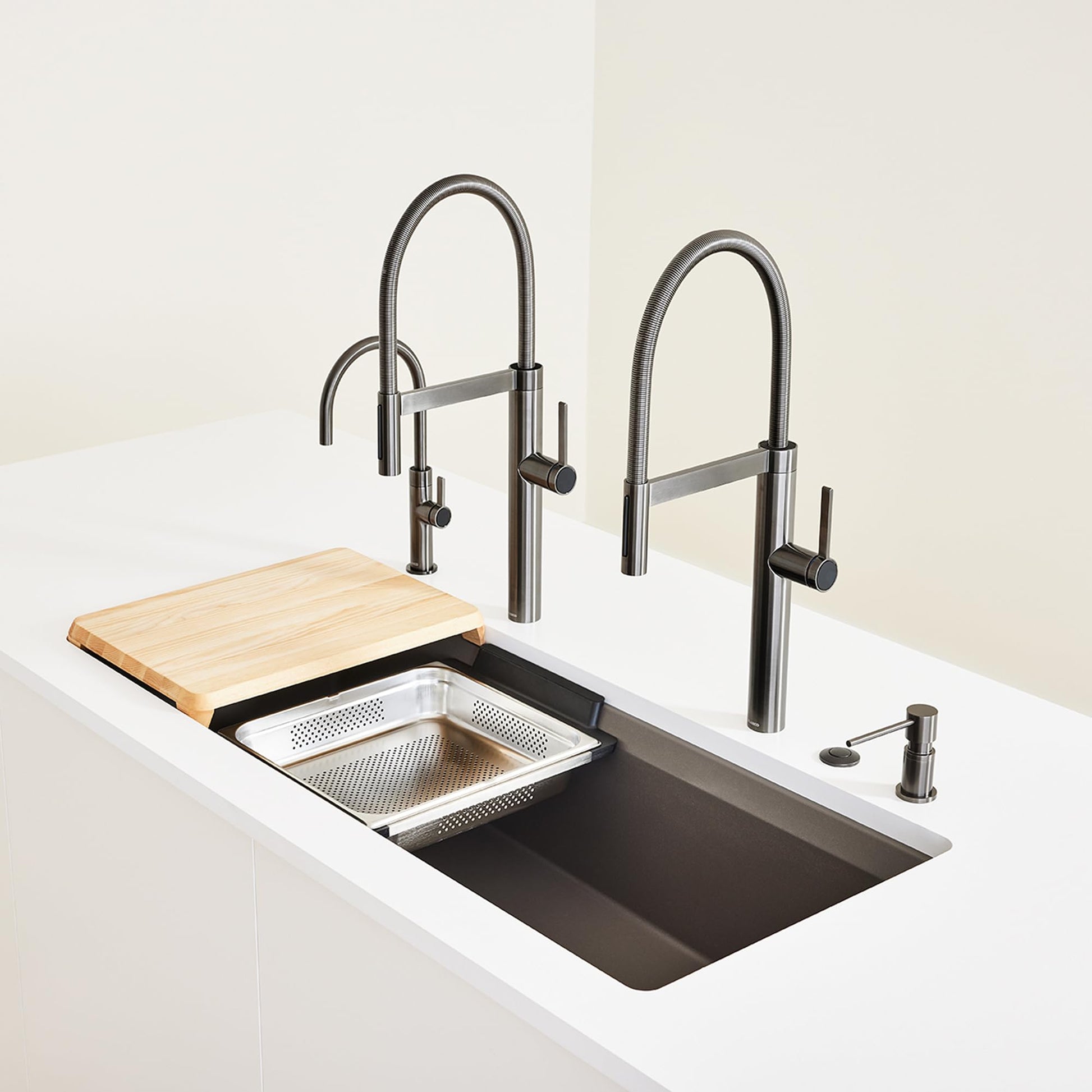 Stainless steel sink colander with perforated and mesh surfaces, wooden cutting board, and two pull-down faucets installed in
