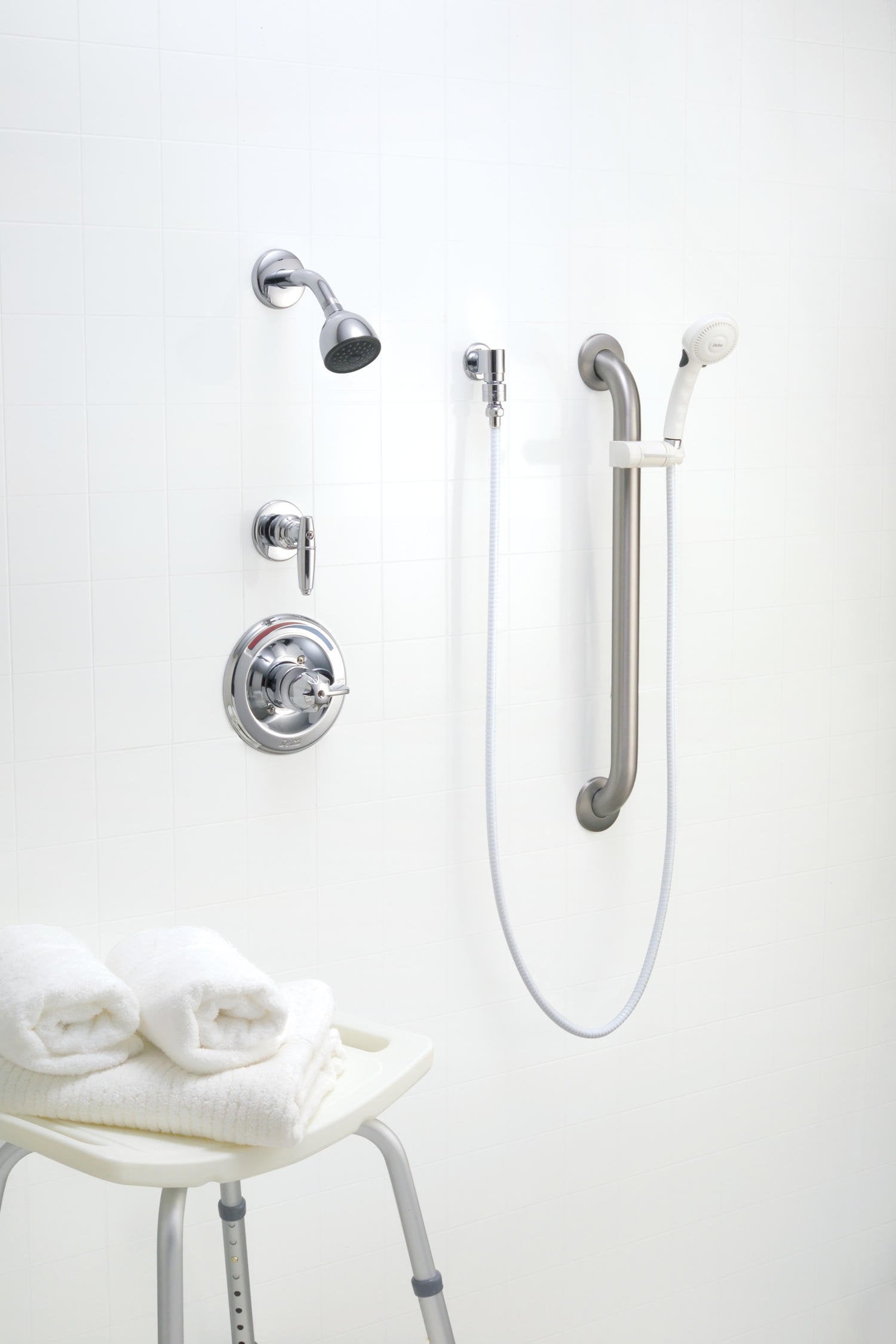 Chrome dual shower system with fixed showerhead, hand shower on hose, diverter valve, single-handle control, and curved grab 