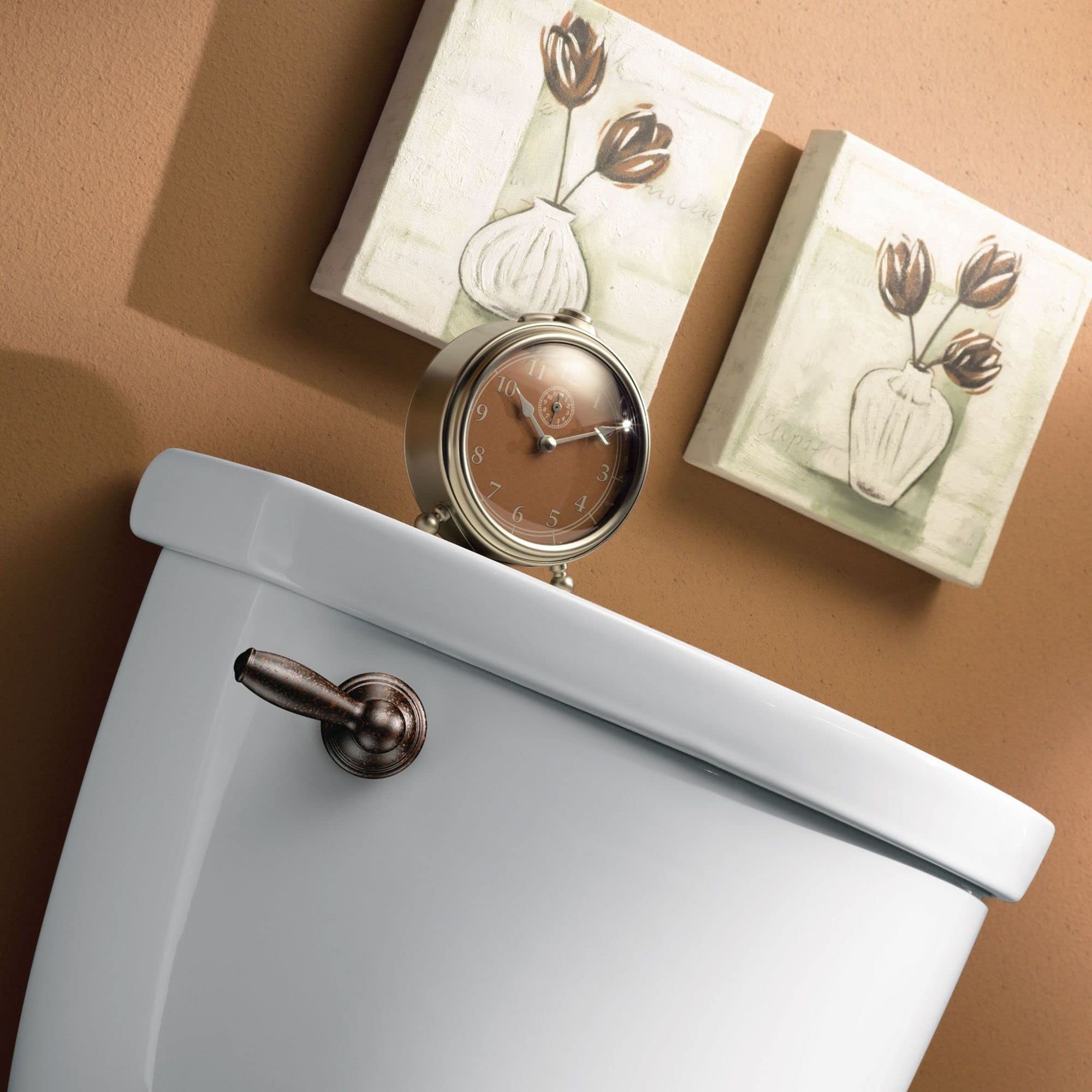 Oil rubbed bronze toilet tank lever mounted on white ceramic tank.