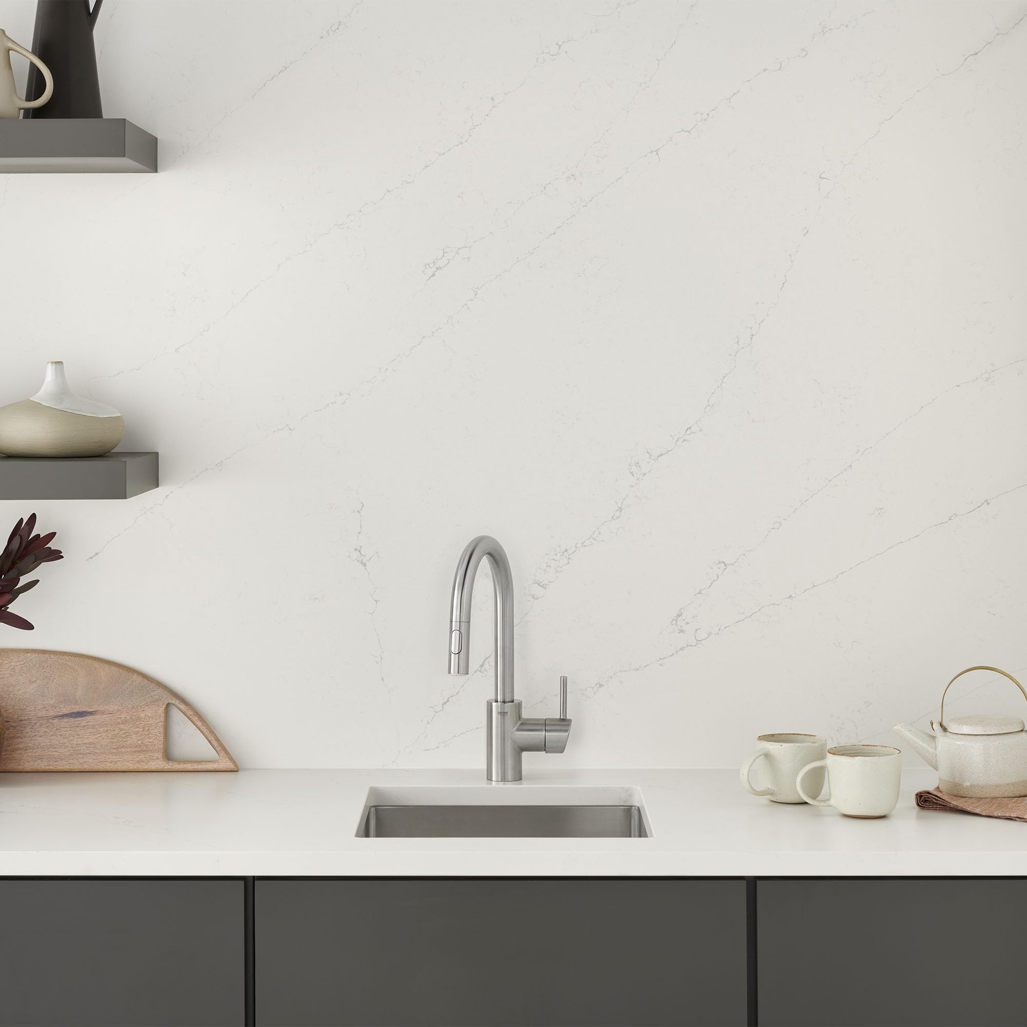 Grohe Concetto single-handle pull-down bar faucet in stainless steel finish mounted above sink.