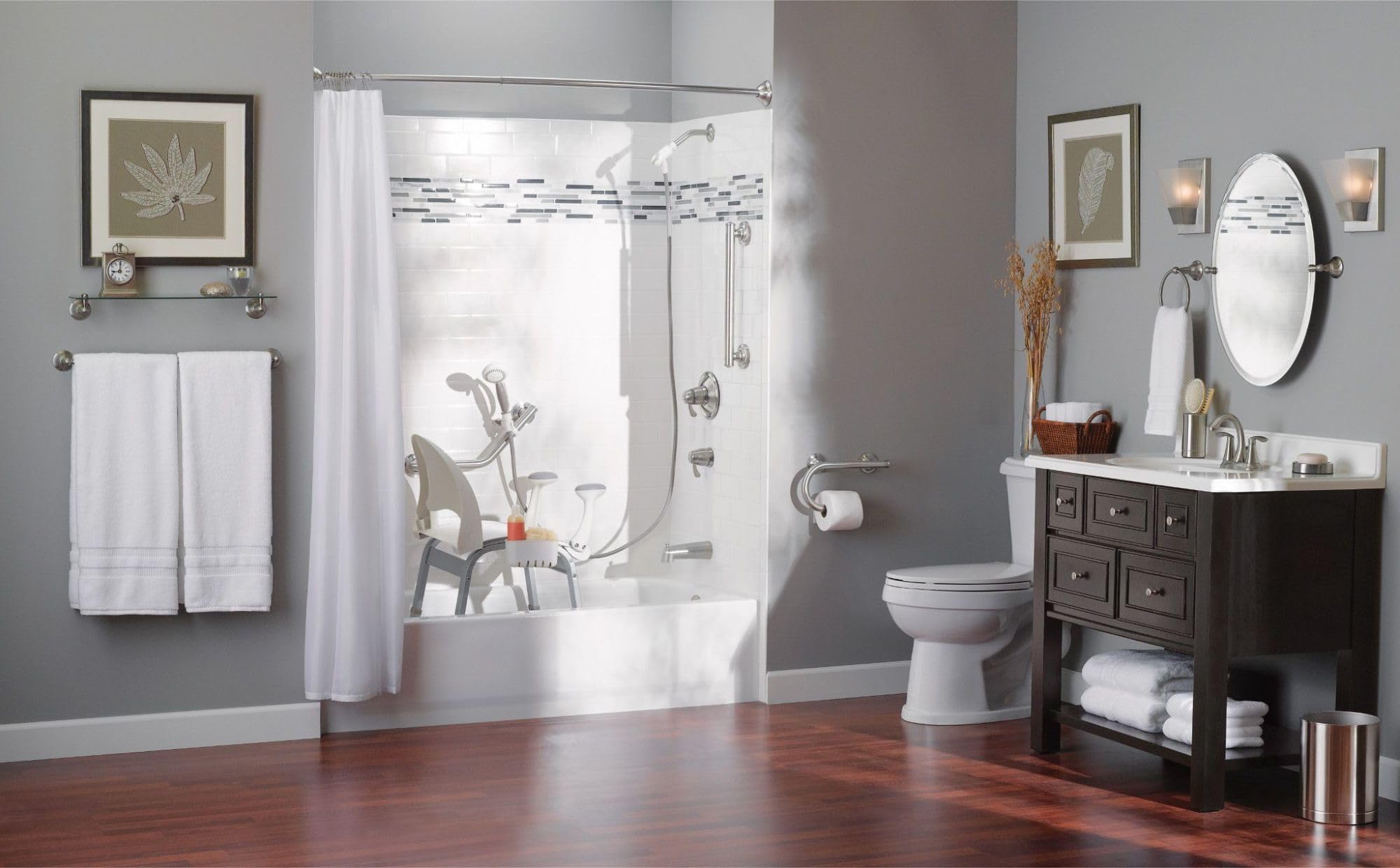 Brushed nickel grab bar mounted horizontally on gray bathroom wall near shower enclosure.