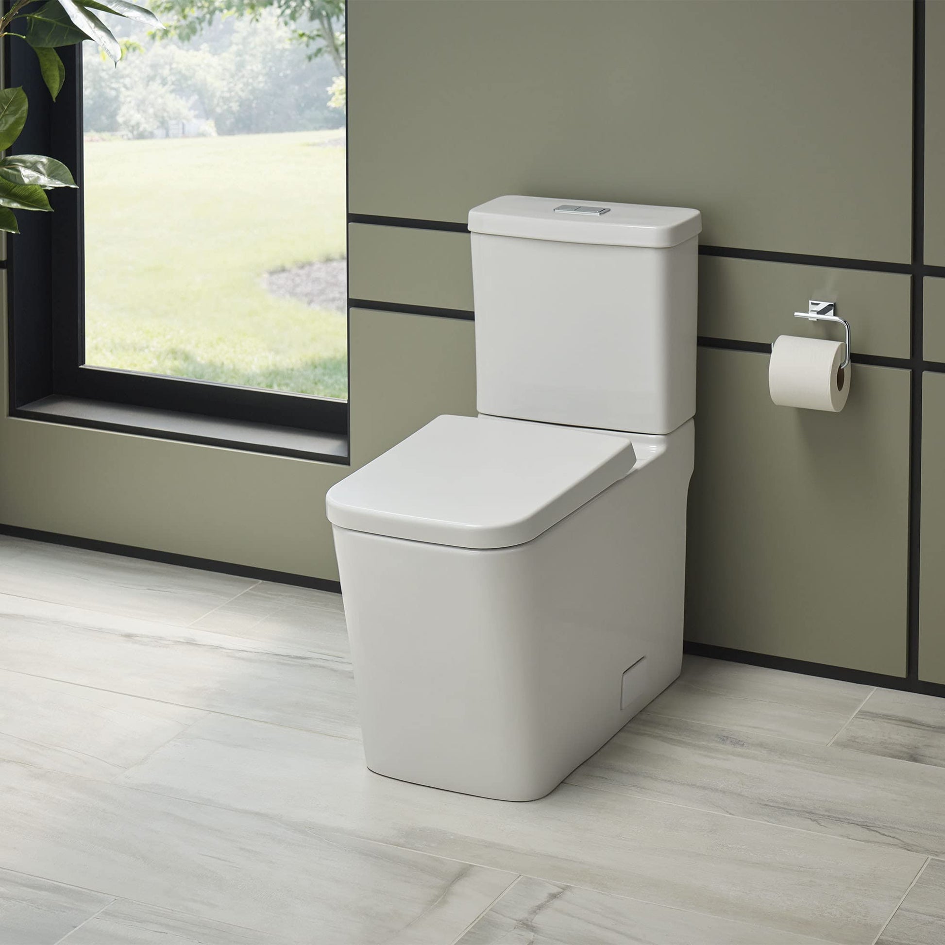 White elongated toilet bowl with closed seat and separate white tank in modern bathroom setting.