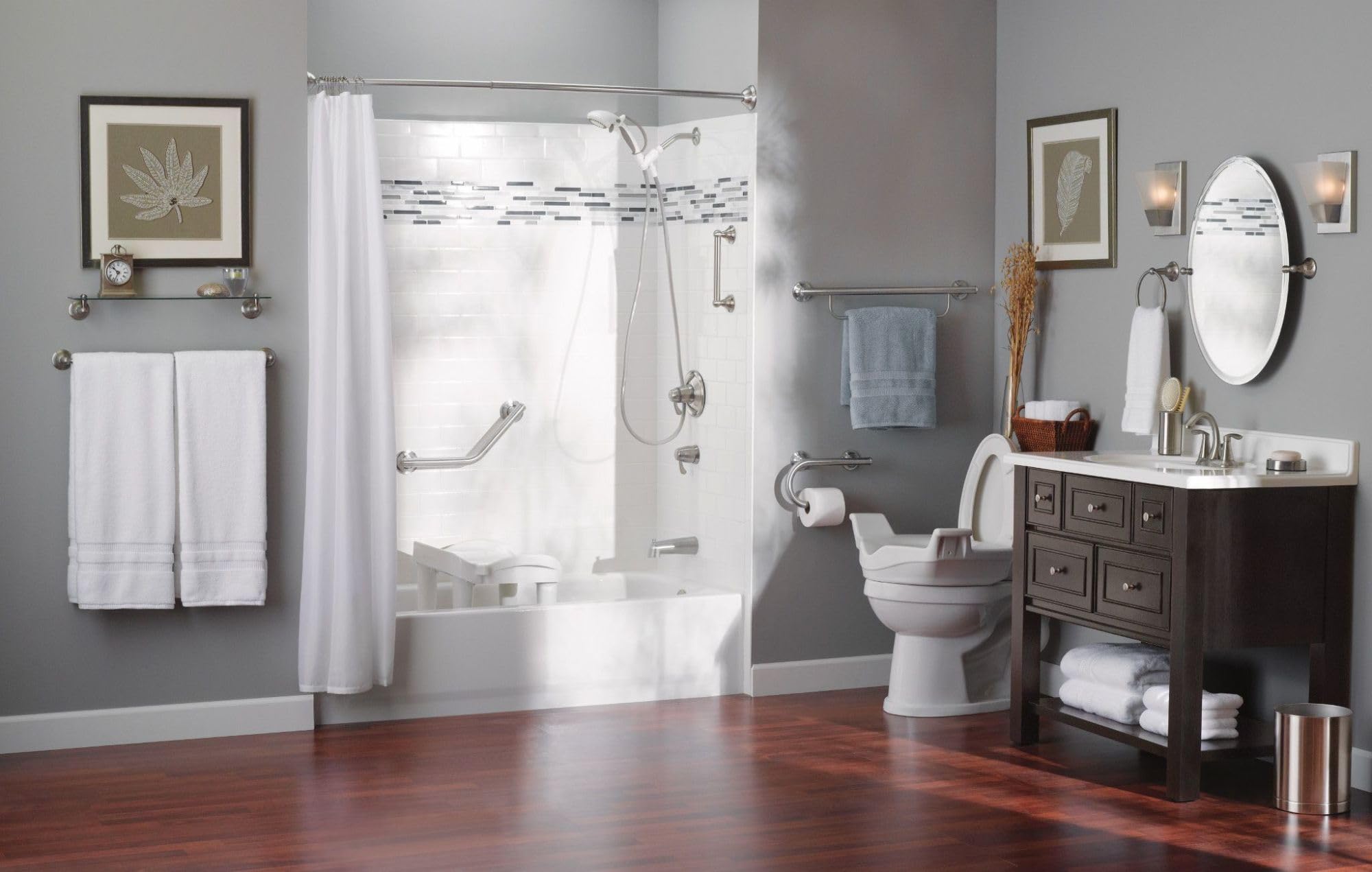 Chrome grab bar with integrated towel bar mounted on shower enclosure wall above toilet.