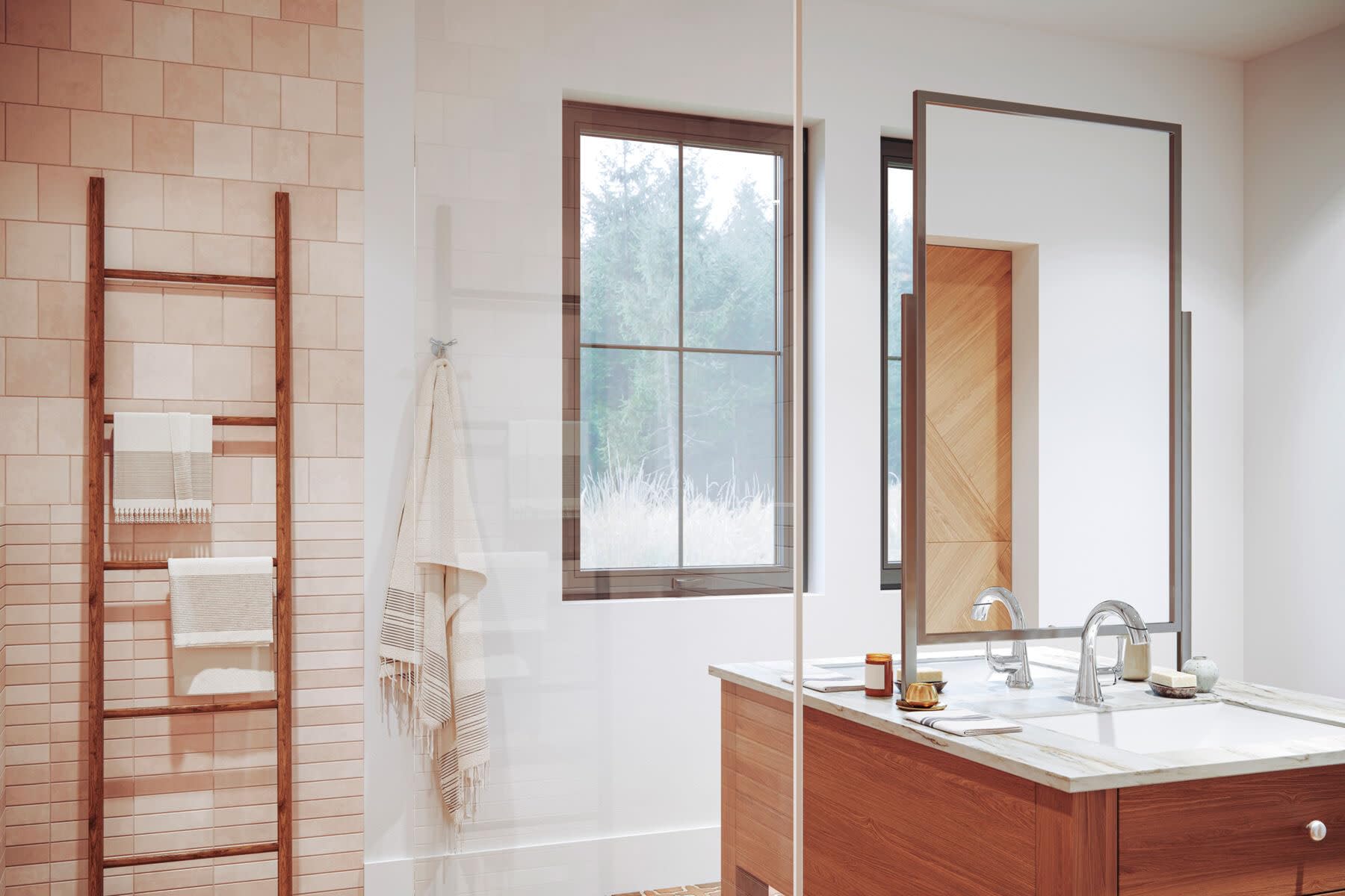 Champagne bronze single handle pull-down faucet installed on white bathroom vanity with wood cabinetry.