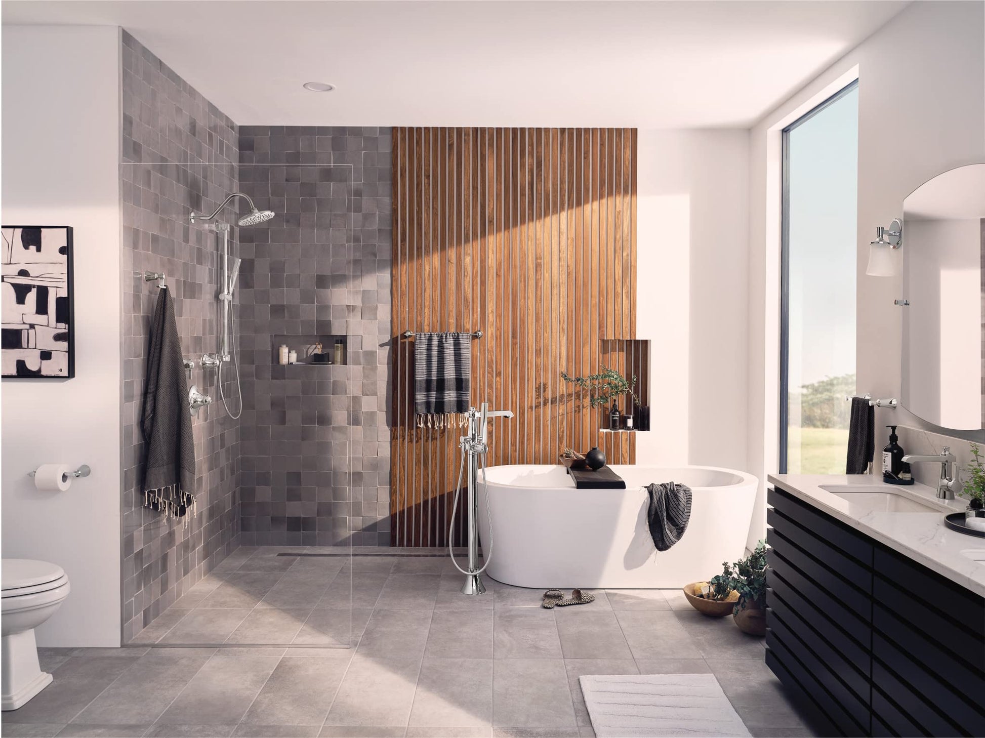 Chrome handheld showerhead with slide bar mounted on gray tiled shower wall in modern bathroom.
