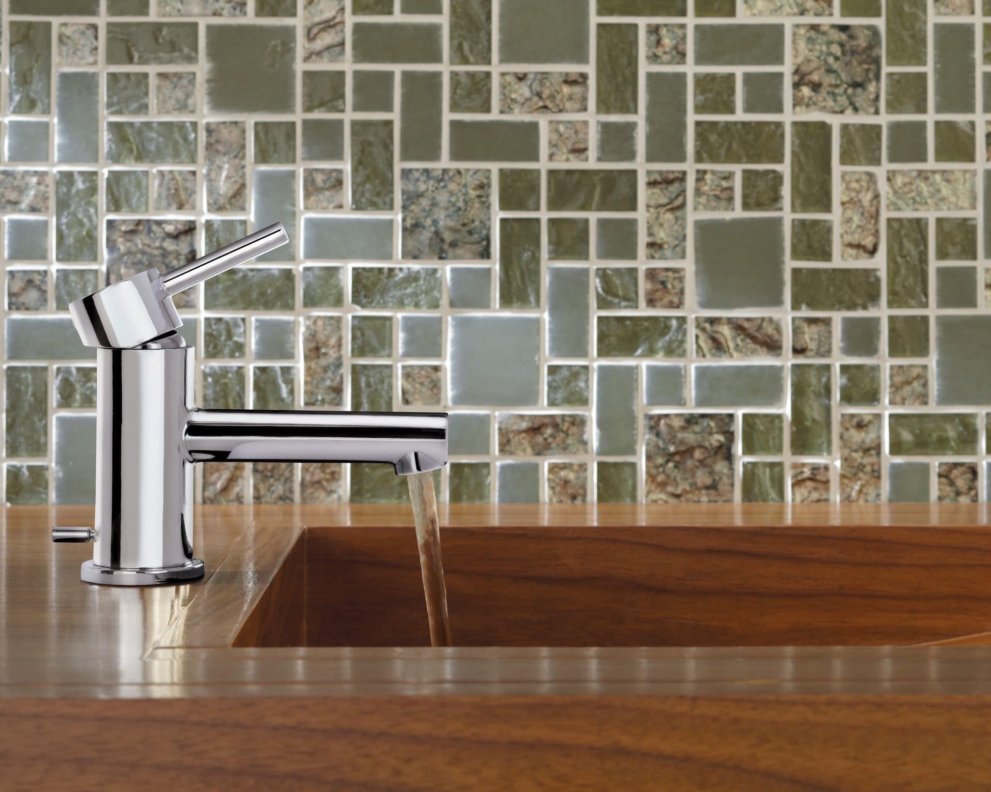 Chrome single-handle bathroom faucet with angled spout mounted on wooden countertop with tile backsplash.