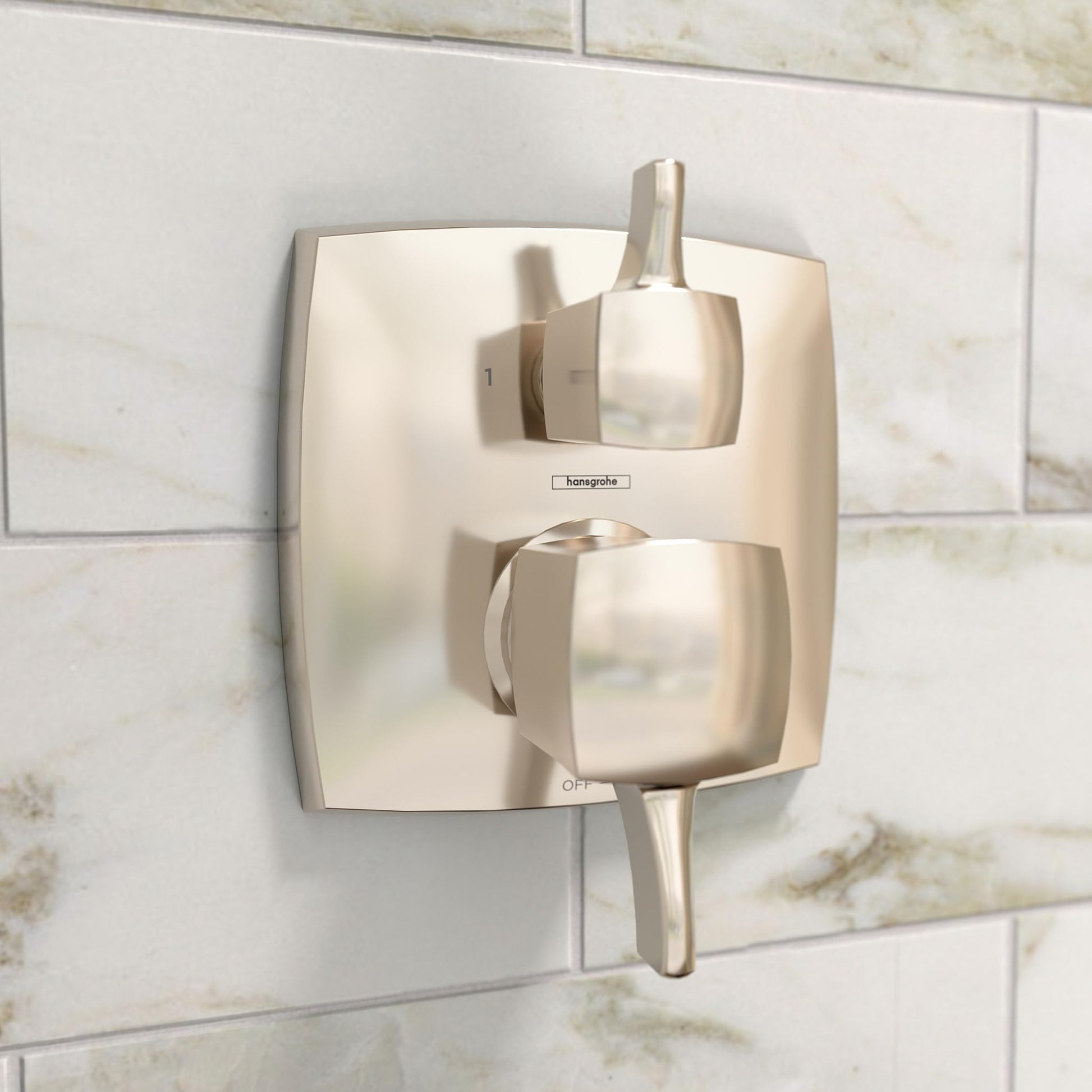 Polished nickel square pressure balance valve trim with lever handles and diverter on marble tile wall.