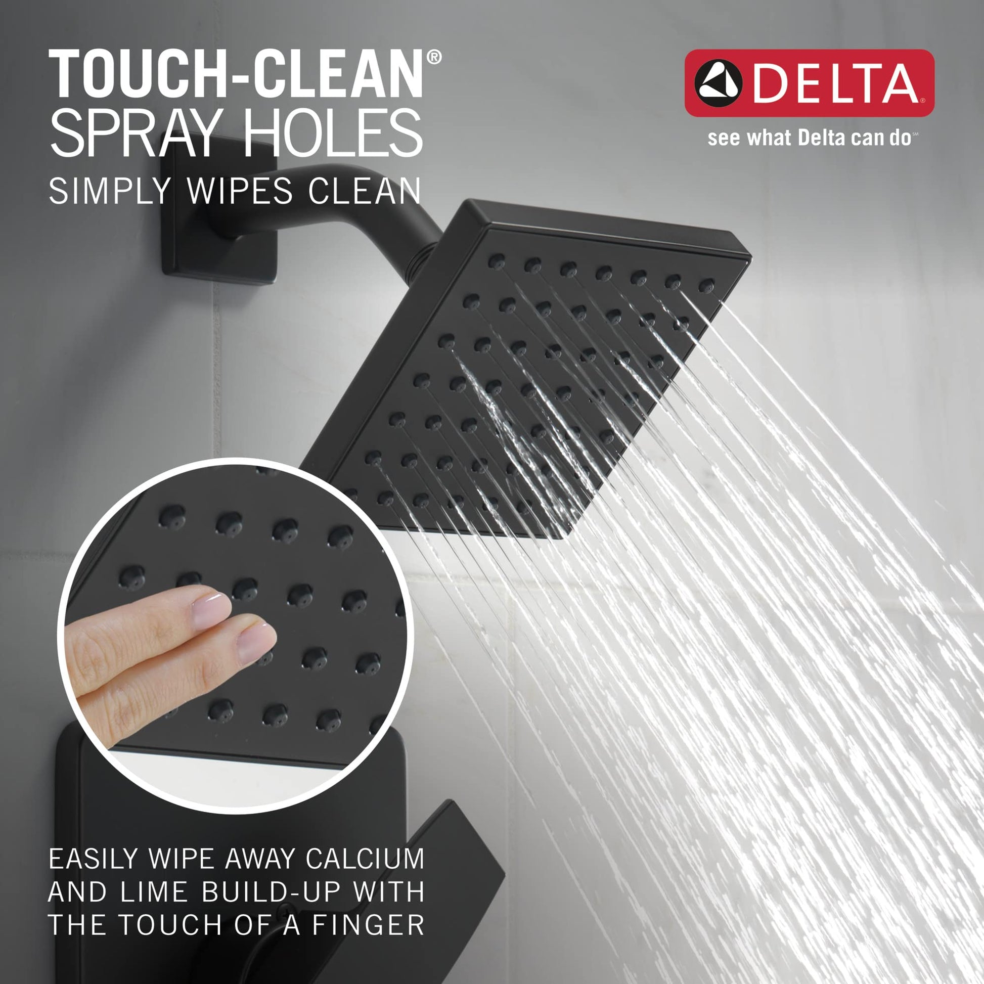 Matte black square showerhead with multiple spray holes mounted on wall bracket, water streaming downward.