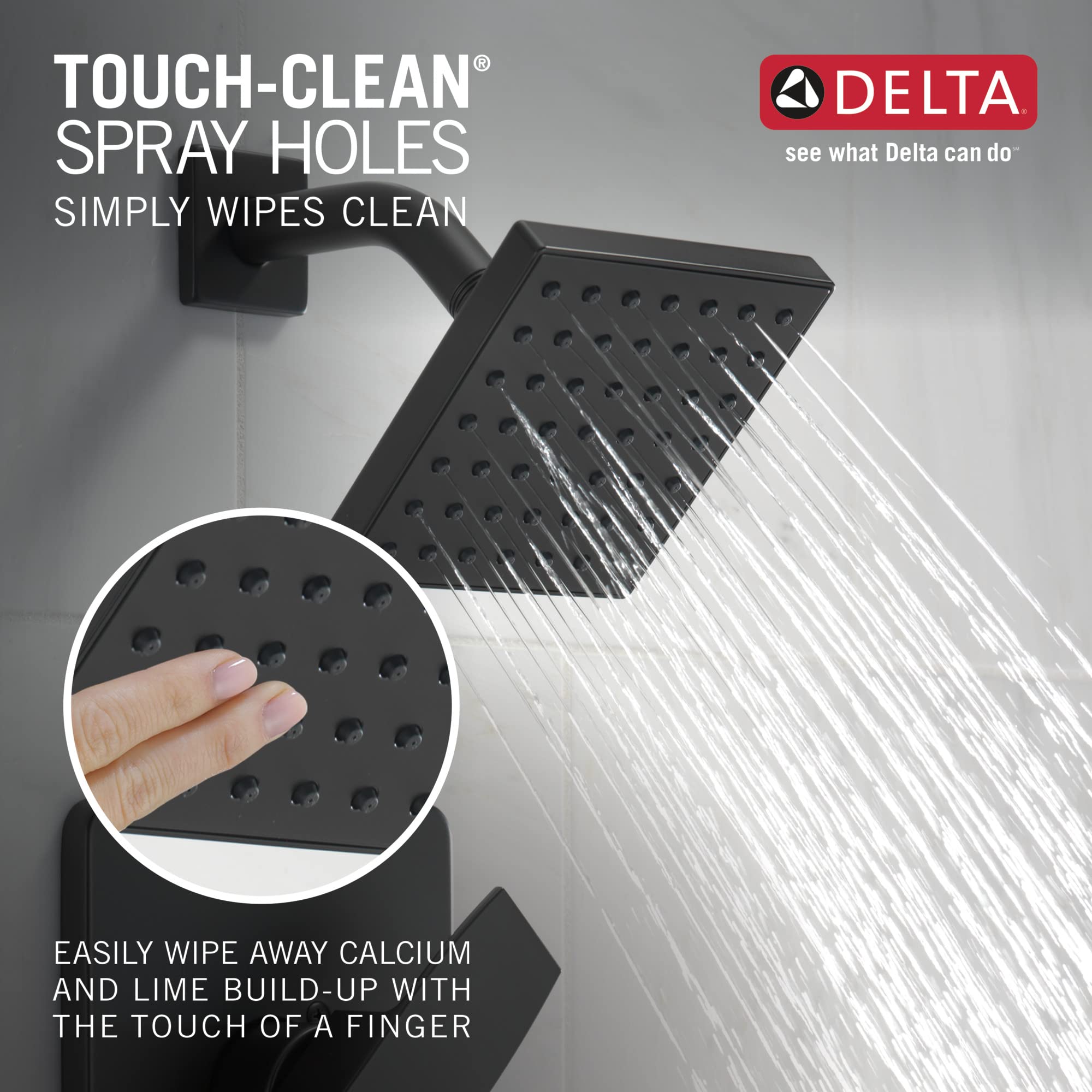 Matte black square showerhead with multiple spray holes mounted on wall bracket, water streaming downward.