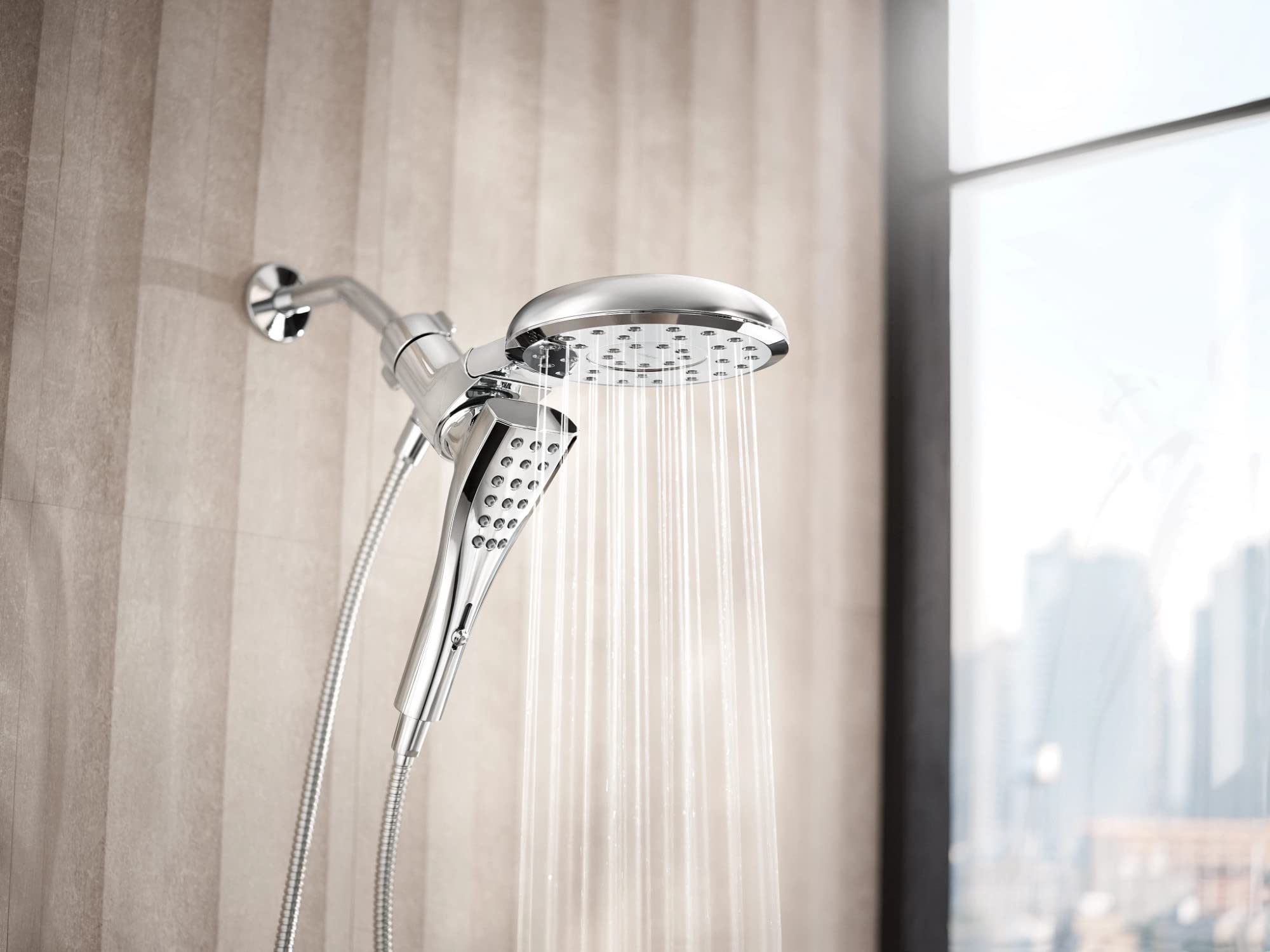 Chrome dual shower head system with overhead rainfall head and angled handheld head mounted on tile wall.