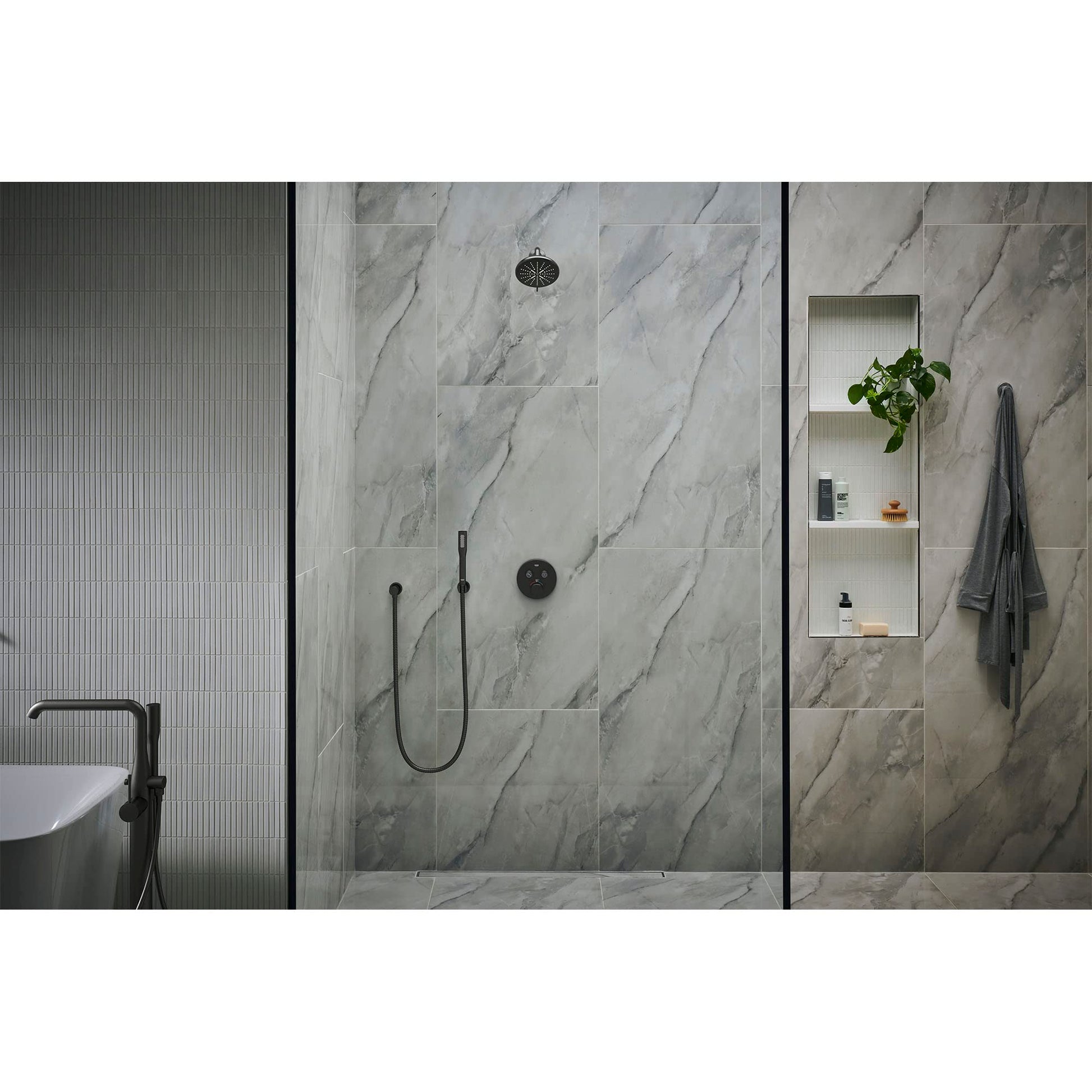 Matte black robe hook mounted on marble bathroom wall next to shower enclosure.